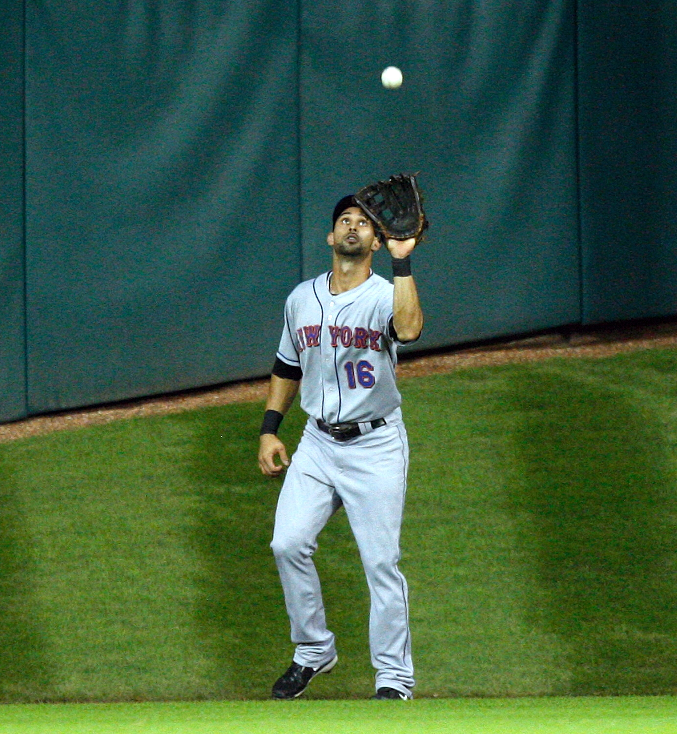 HOUSTON - AUGUST 19:  Center fielder Ange Pagan #16 of the New York Mets makes a catch near the wall during a game against the Houston Astros at Minute Maid Park on August 19, 2010 in Houston, Texas.  (Photo by Bob Levey/Getty Images)