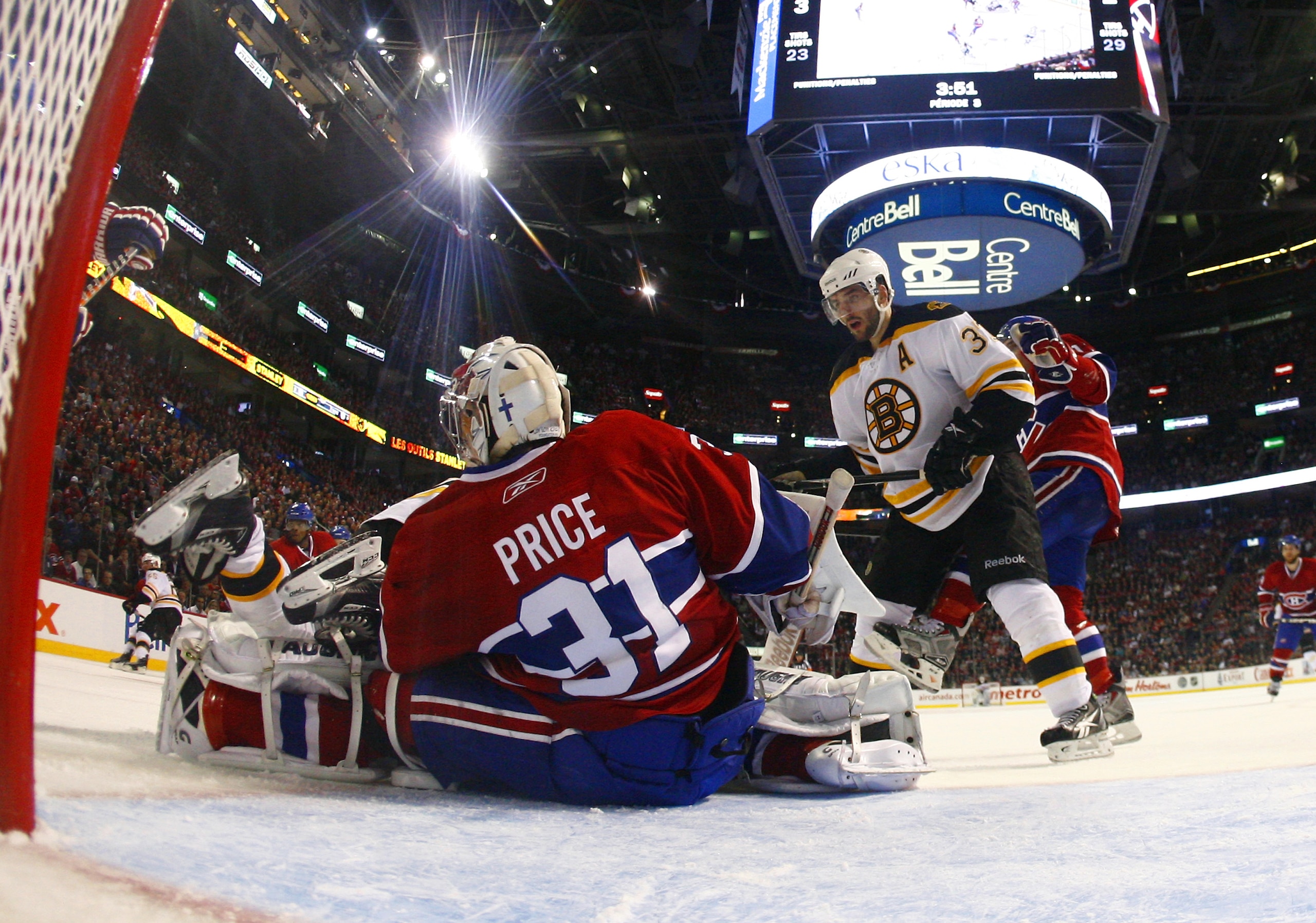 MONTREAL, CANADA - APRIL 18:  Carey Price #31 of the Montreal Canadiens makes a save down low while Patrice Bergeron #37 of the Boston Bruins skates in looking for a rebound in Game Three of the Eastern Conference Quarterfinals during the 2011 NHL Stanley