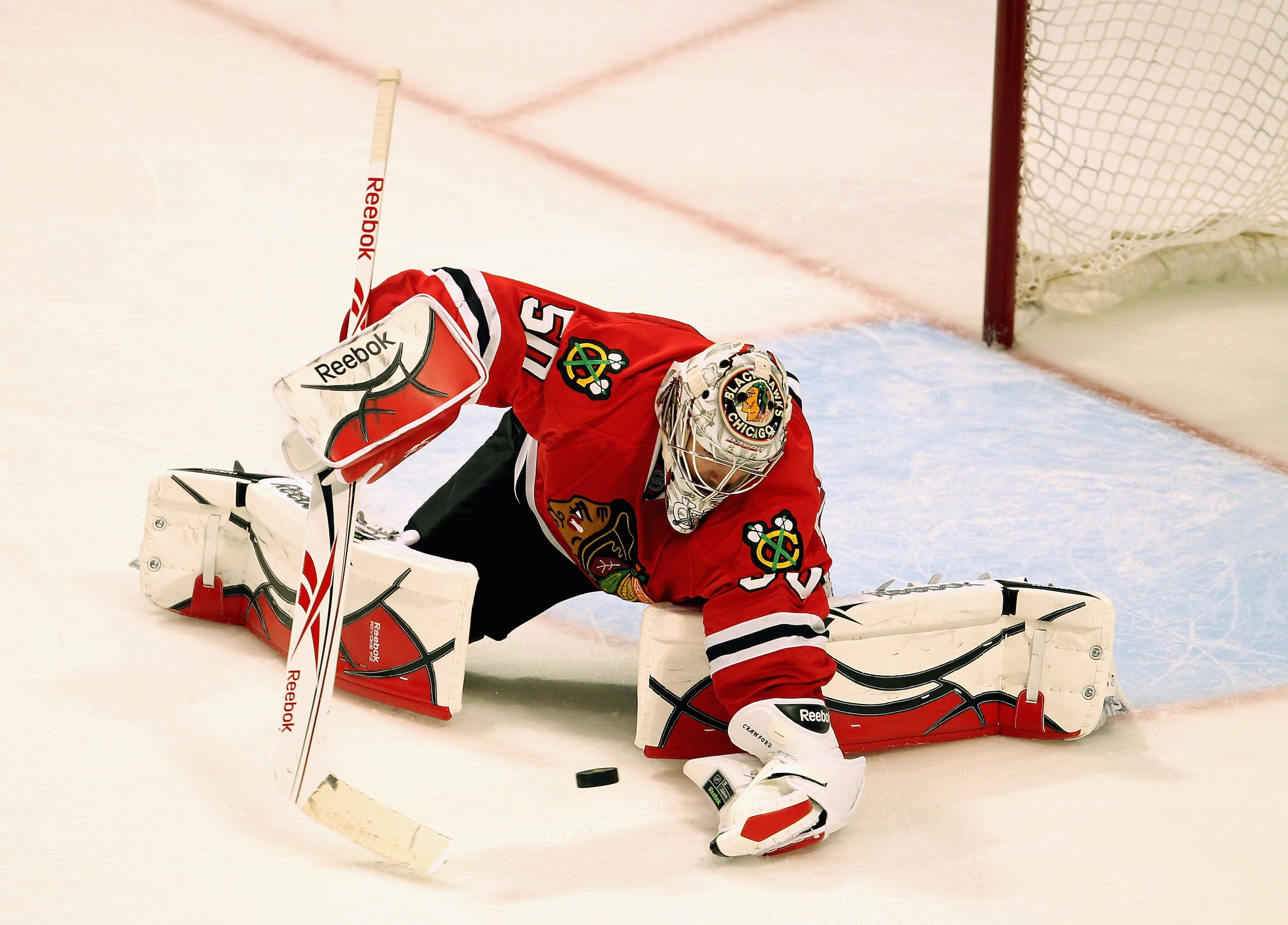 CHICAGO, IL - APRIL 19: Corey Crawford #50 of the Chicago Blackhawks makes a save against the Vancouver Canucks in Game Four of the Western Conference Quarterfinals during the 2011 NHL Stanley Cup Playoffs at the United Center on April 19, 2011 in Chicago