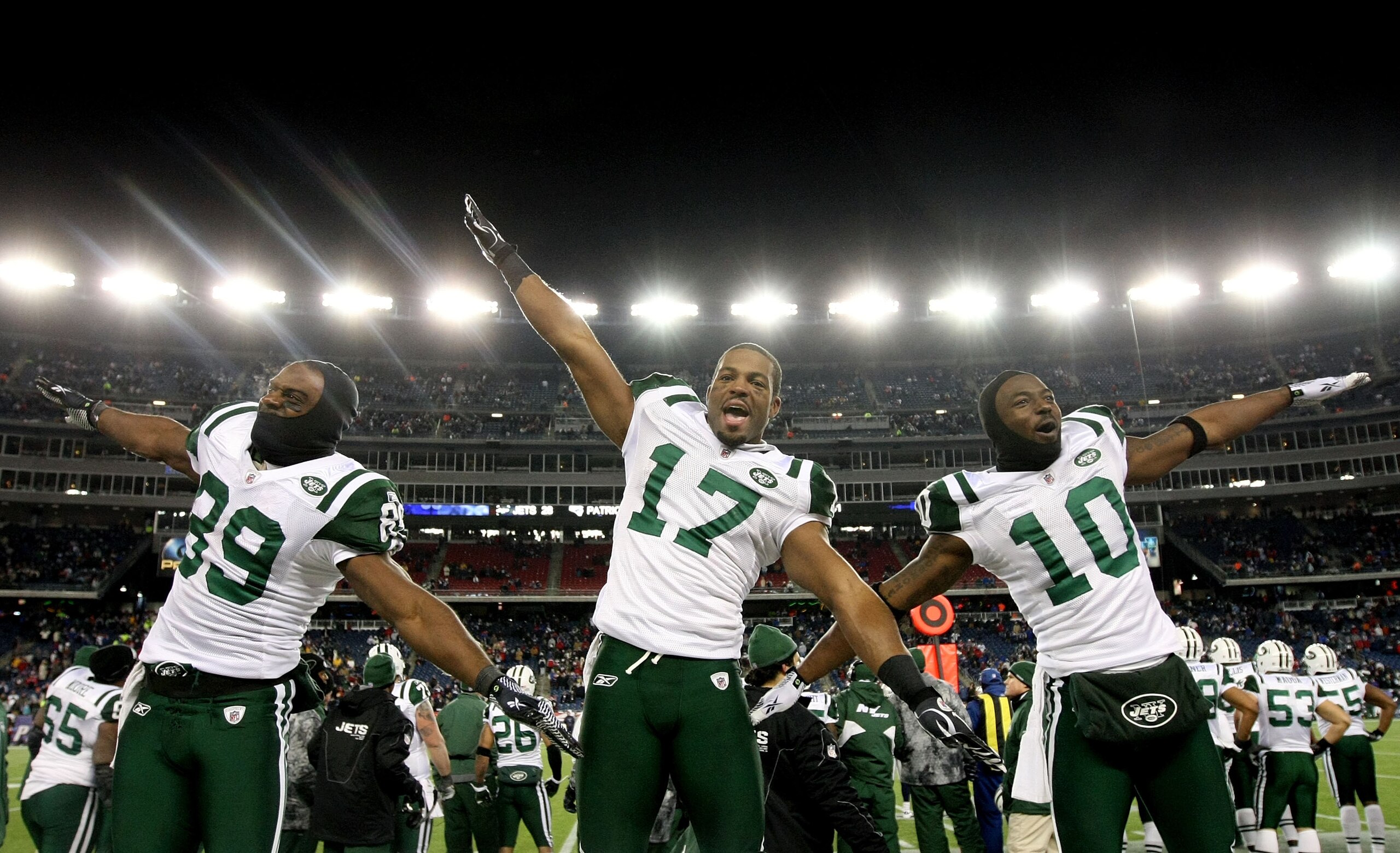 FOXBORO, MA - JANUARY 16:  Jerricho Cotchery #89, Braylon Edwards #17 and Santonio Holmes #10 of the New York Jets celebrate their 28 to 21 victory over the New England Patriots during their 2011 AFC divisional playoff game at Gillette Stadium on January 