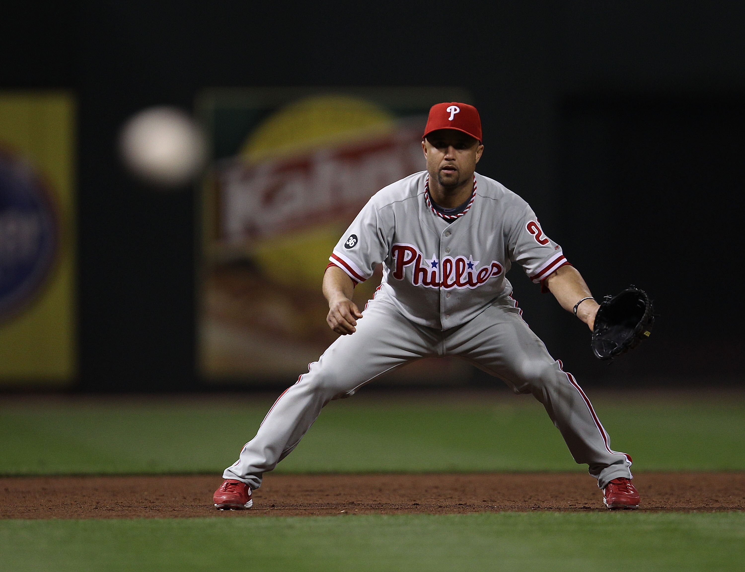 CINCINNATI - OCTOBER 10: Placido Polanco #27 of the Philadelphia Phillies keeps his eyes on a pitch thrown by teammate Cole Hamels against the Cincinnati Reds during game 3 of the NLDS at Great American Ball Park on October 10, 2010 in Cincinnati, Ohio. T