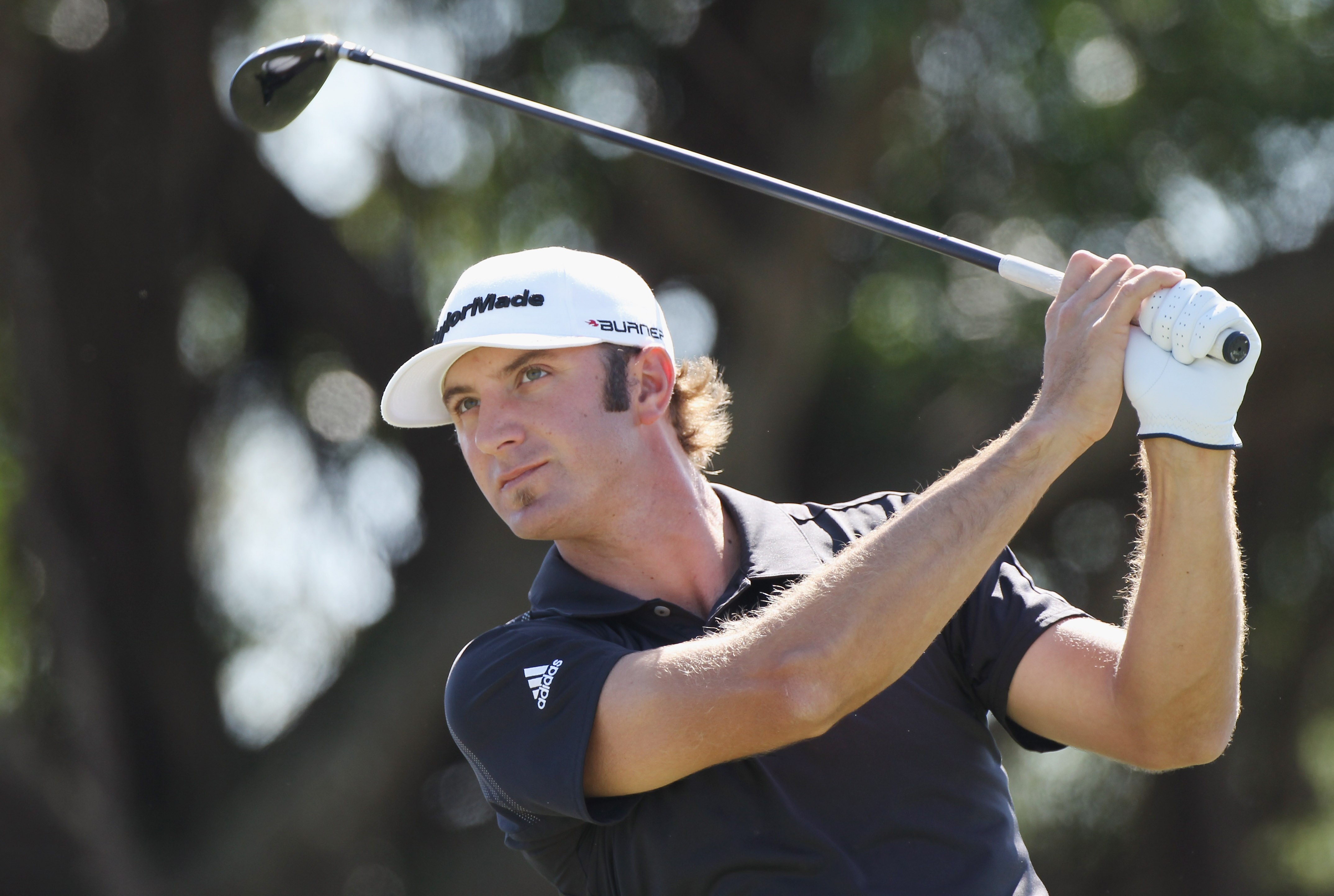 DORAL, FL - MARCH 13:  Dustin Johnson watches his tee shot on the fifth hole during the final round of the 2011 WGC- Cadillac Championship at the TPC Blue Monster at the Doral Golf Resort and Spa on March 13, 2011 in Doral, Florida.  (Photo by Sam Greenwo