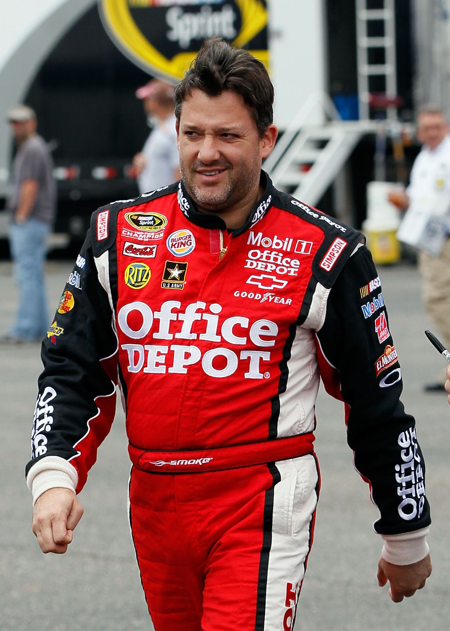 TALLADEGA, AL - APRIL 15:  Tony Stewart, driver of the #14 Office Depot/Mobil 1 Chevrolet, walks in the garage area during practice for the NASCAR Sprint Cup Series Aaron's 499 at Talladega Superspeedway on April 15, 2011 in Talladega, Alabama.  (Photo by