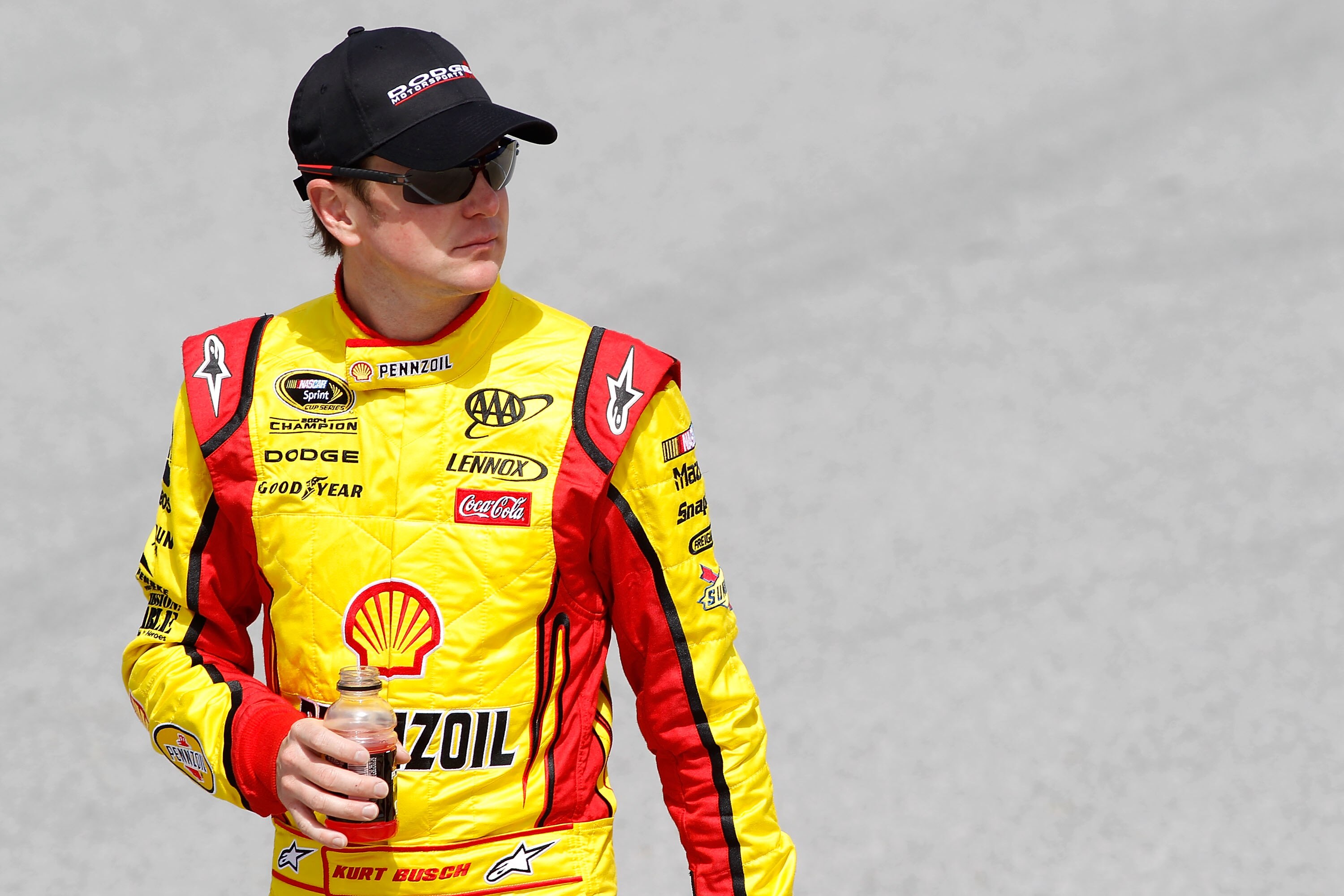 TALLADEGA, AL - APRIL 16:  Kurt Busch, driver of the #22 Shell/Pennzoil-AAA Dodge, walks on the grid during qualifying for the NASCAR Sprint Cup Series Aaron's 499 at Talladega Superspeedway on April 16, 2011 in Talladega, Alabama.  (Photo by Todd Warshaw