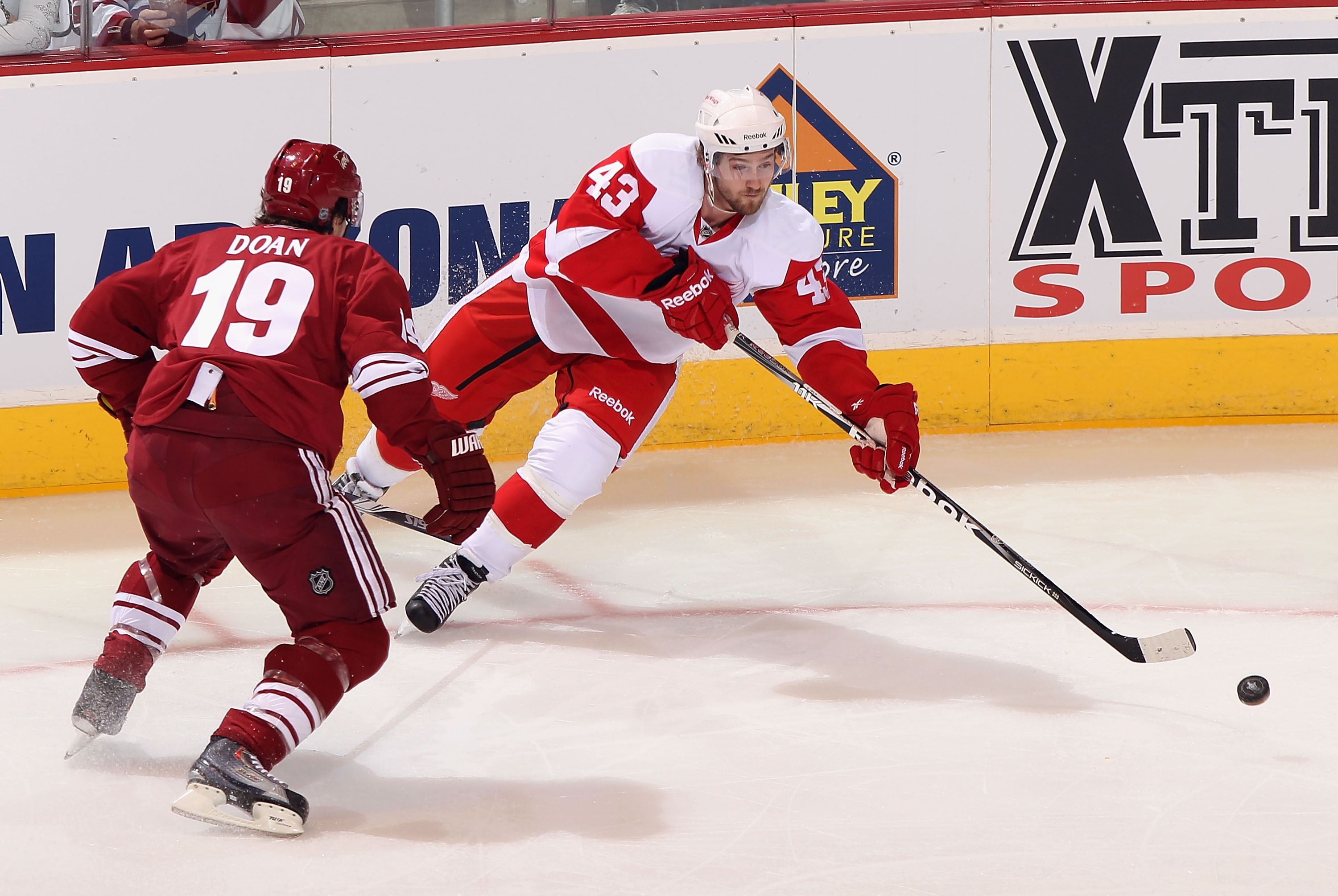 GLENDALE, AZ - APRIL 18: Darren Helm #43 of the Detroit Red Wings skates with the puck under pressure from Shane Doan #19 of the Phoenix Coyotes in Game Three of the Western Conference Quarterfinals during the 2011 NHL Stanley Cup Playoffs at Jobing.com GLENDALE, AZ - APRIL 18: Darren Helm #43 of the Detroit Red Wings skates with the puck under pressure from Shane Doan #19 of the Phoenix Coyotes in Game Three of the Western Conference Quarterfinals during the 2011 NHL Stanley Cup Playoffs at Jobing.com
