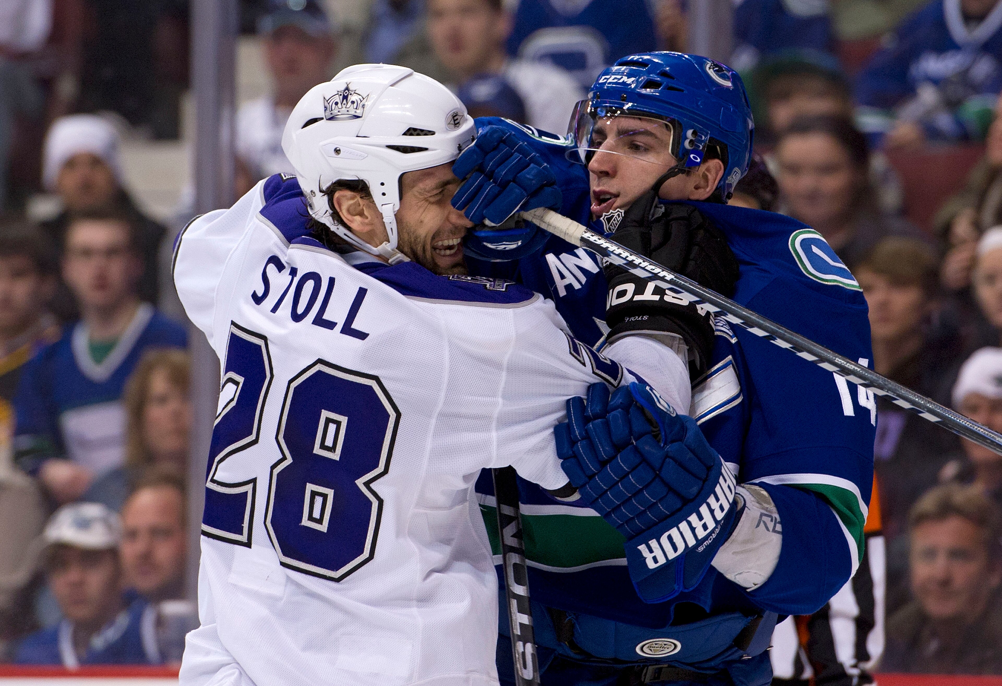 VANCOUVER, CANADA - MARCH 31: Alexandre Burrows #14 of the Vancouver Canucks and Jarret Stoll #28 of the Los Angeles Kings push and shove after the whistle during the second period in NHL action on March 31, 2011 at Rogers Arena in Vancouver, BC, Canada.