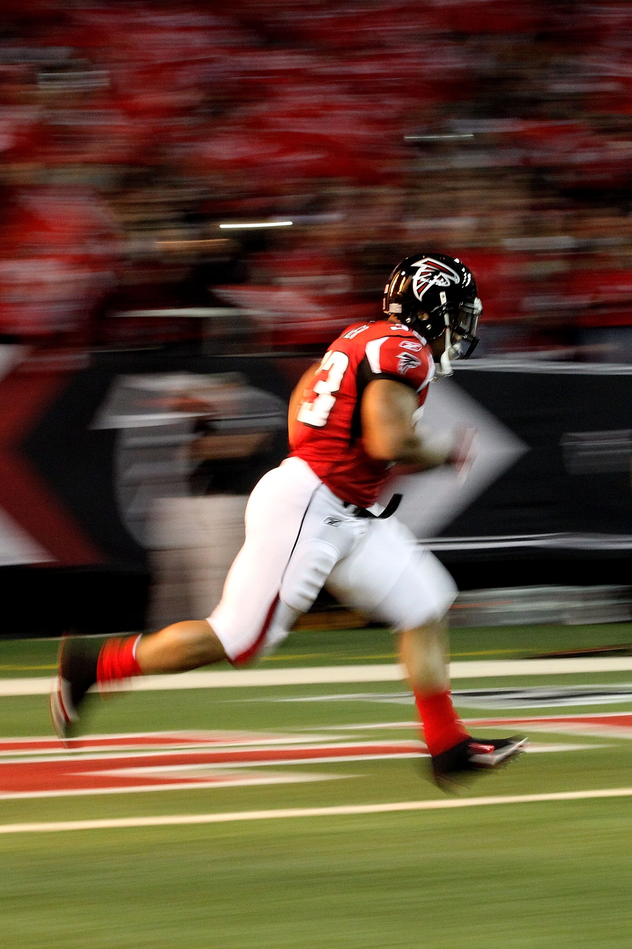 ATLANTA, GA - JANUARY 15:  Michael Turner #33 of the Atlanta Falcons runs onto the field during player introductions against the Green Bay Packers during their 2011 NFC divisional playoff game at Georgia Dome on January 15, 2011 in Atlanta, Georgia.  The