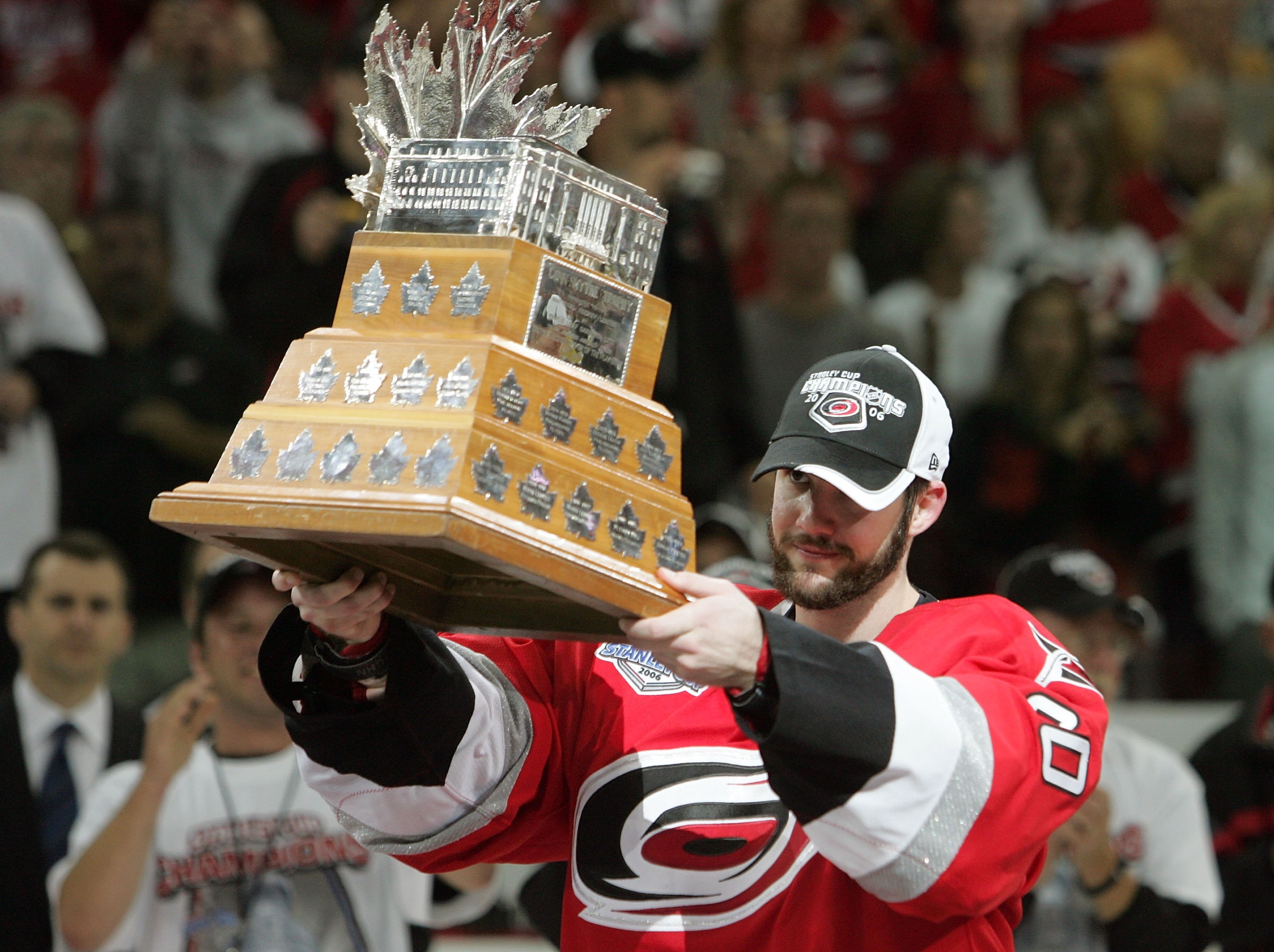 RALEIGH, NC - JUNE 19:  Goaltender Cam Ward #30 of the Carolina Hurricanes raises the Conn Smythe trophy after defeating the Edmonton Oilers in game seven of the 2006 NHL Stanley Cup Finals on June 19, 2006 at the RBC Center in Raleigh, North Carolina. Th