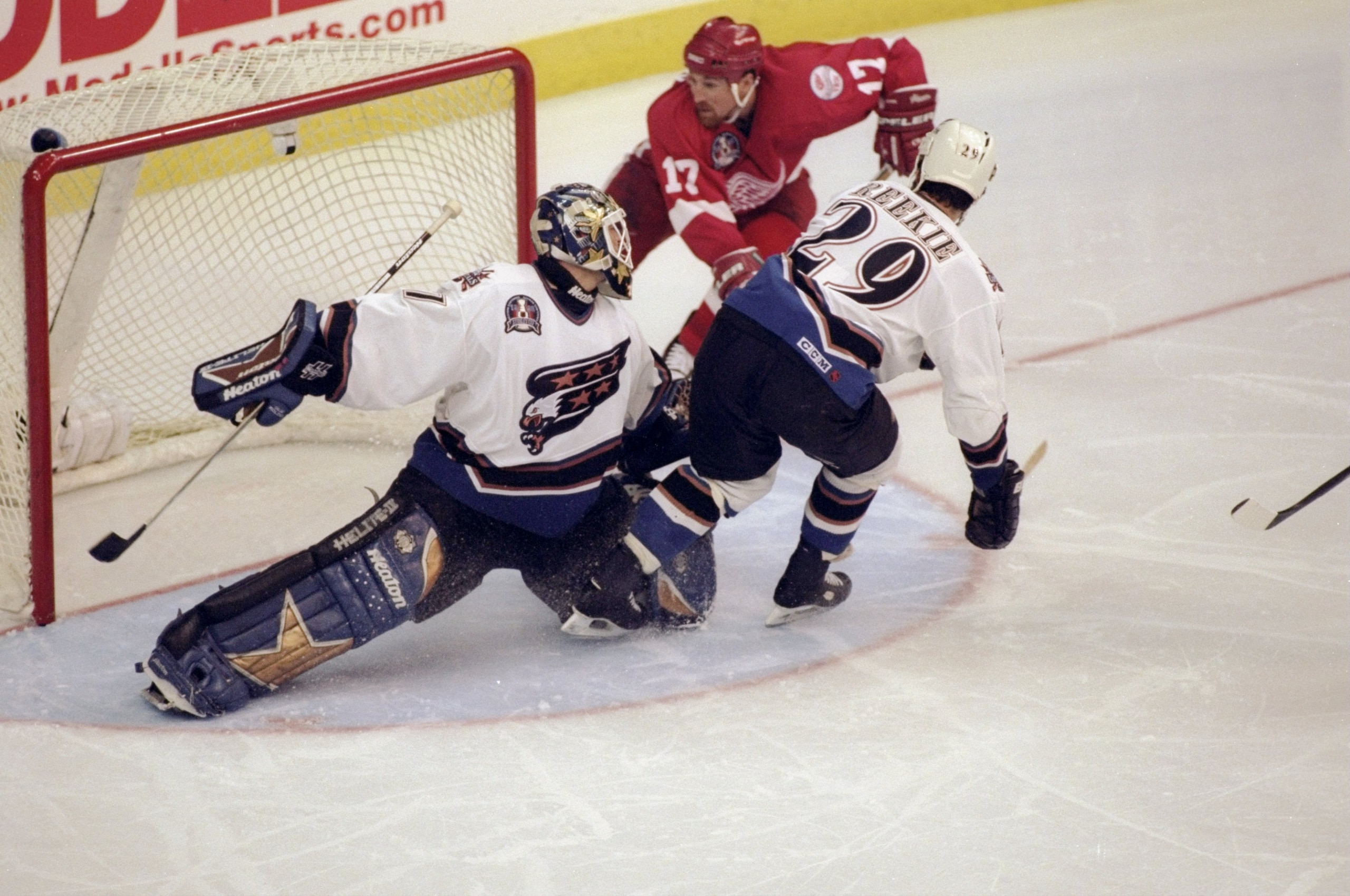 16 Jun 1998: Olaf Kolzig #37 and Joe Reekie #29 of the Washington Capitals in action against Doug Brown #17 the Detroit Red Wings during the Stanley Cup Finals game at the MCI Center in Washington, D. C.. The Red Wings defeated the Capitals 4-1. Mandator 16 Jun 1998: Olaf Kolzig #37 and Joe Reekie #29 of the Washington Capitals in action against Doug Brown #17 the Detroit Red Wings during the Stanley Cup Finals game at the MCI Center in Washington, D. C.. The Red Wings defeated the Capitals 4-1. Mandator