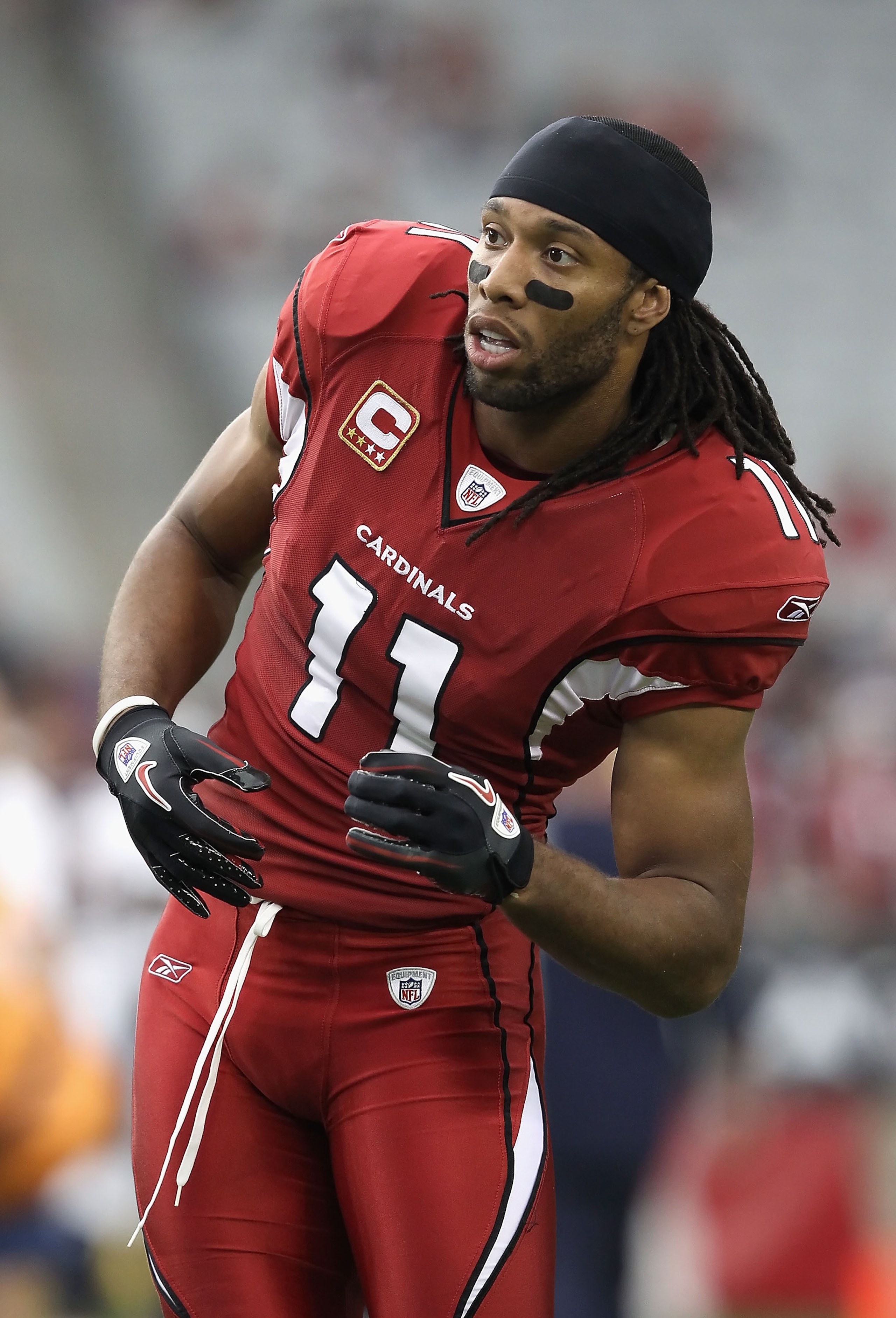 GLENDALE, AZ - DECEMBER 12:  Wide receiver Larry Fitzgerald #11 of the Arizona Cardinals warms up before the NFL game against the Denver Broncos at the University of Phoenix Stadium on December 12, 2010 in Glendale, Arizona. The Cardinals defeated the Bro
