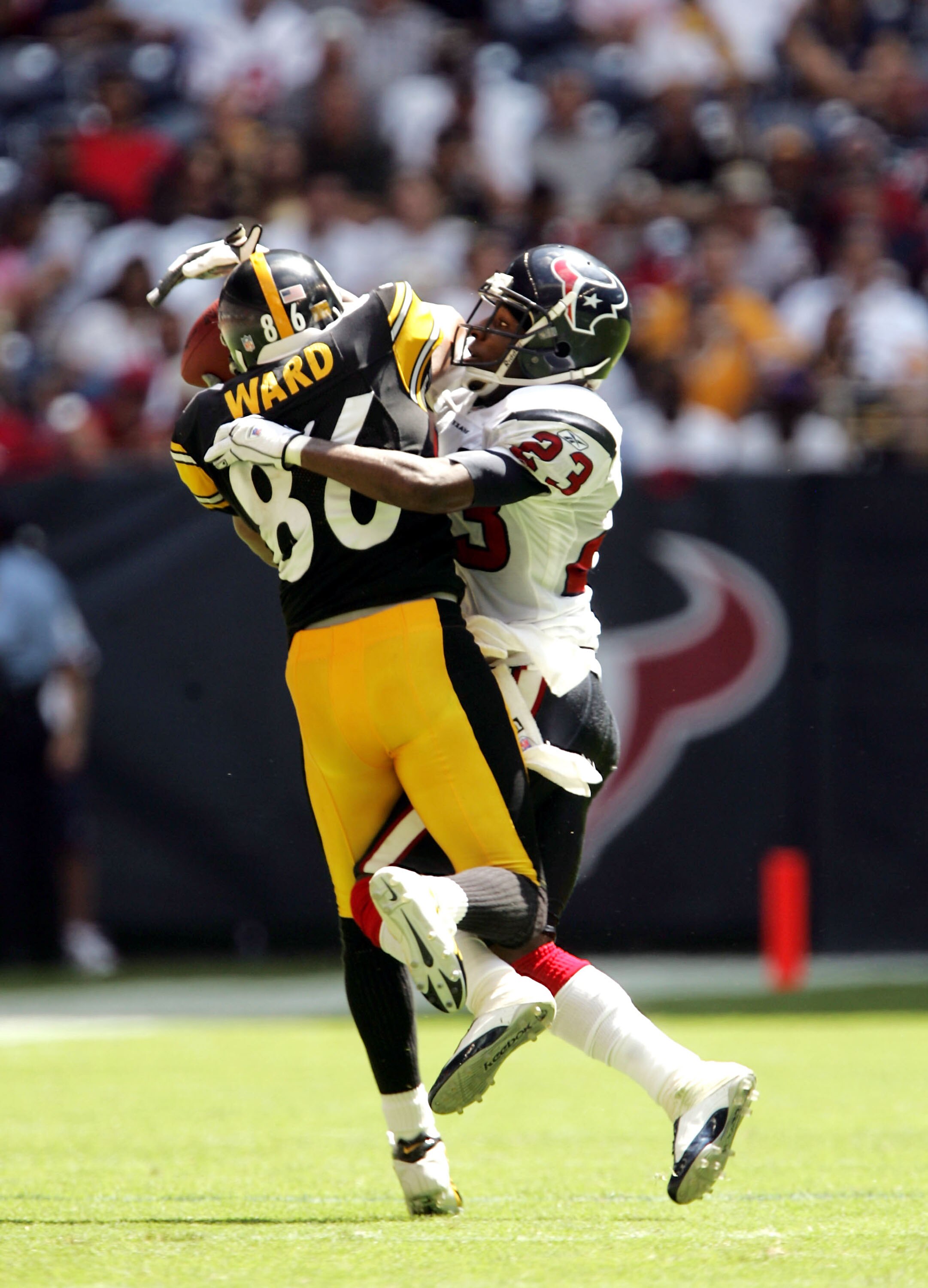 HOUSTON - SEPTEMBER 18:  Cornerback Dunta Robinson #23 of the Houston Texans breaks up a pass intende for wide receiver Hines Ward #86 of the Pittsburgh Steelers on September 18, 2005 at Reliant Stadium in Houston, Texas. The Steelers won 27-7.  (Photo by
