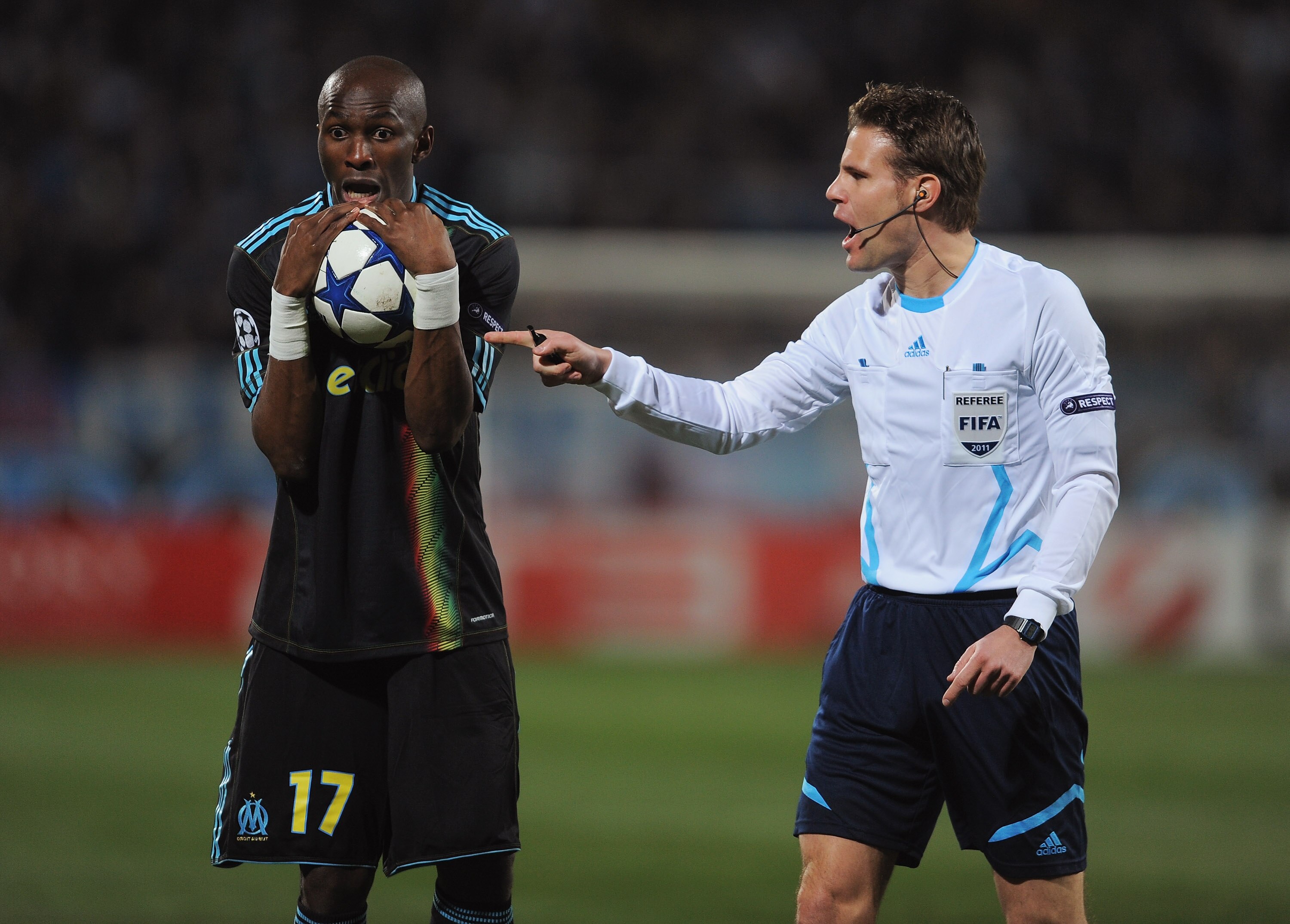 MARSEILLE, FRANCE - FEBRUARY 23:  Stephane Mbia of Marseille exchanges words with referee Felix Brych of Germany during the UEFA Champions League round of 16 first leg match between Marseille and Manchester United at the Stade Velodrome on February 23, 20