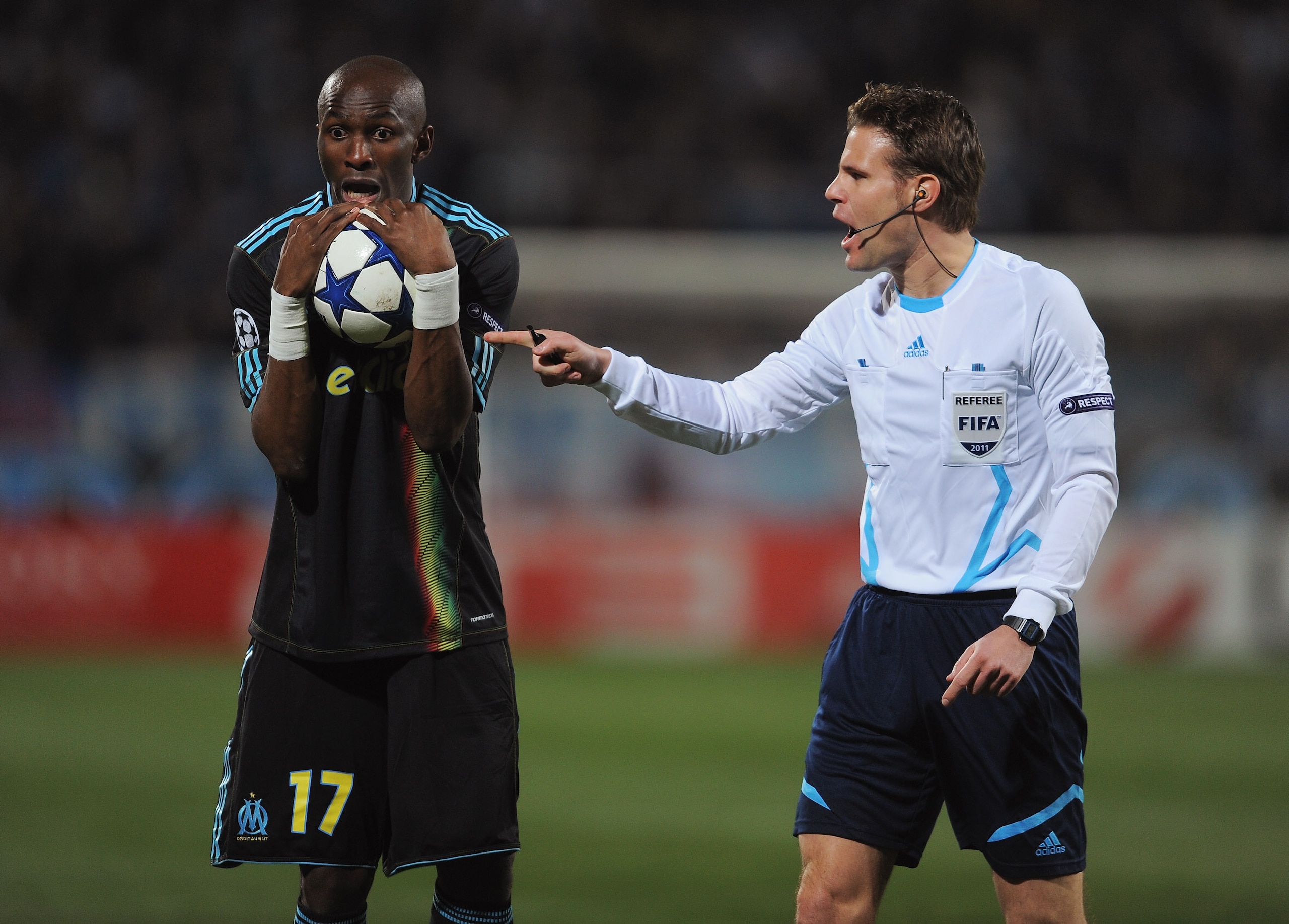 MARSEILLE, FRANCE - FEBRUARY 23:  Stephane Mbia of Marseille exchanges words with referee Felix Brych of Germany during the UEFA Champions League round of 16 first leg match between Marseille and Manchester United at the Stade Velodrome on February 23, 20