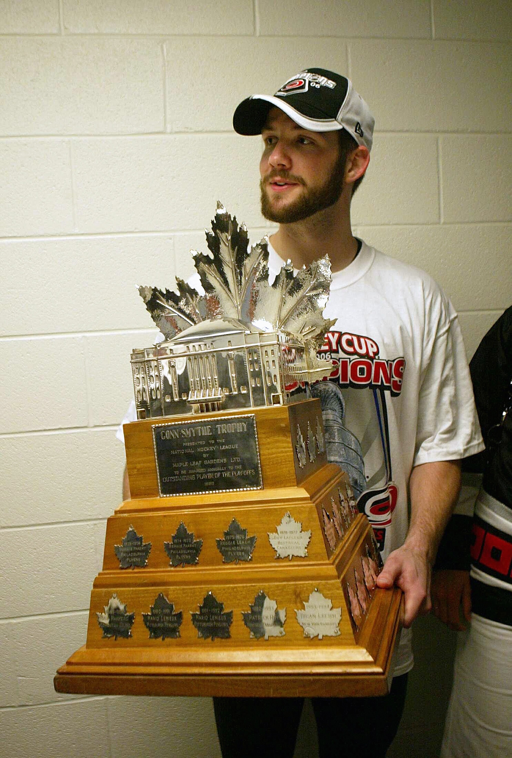 RALEIGH, NC - JUNE 19:  Goaltender Cam Ward of the Carolina Hurricanes stands in the locker room hallway with the Conne Smythe Trophy for the Most Valuable Player in the NHL Playoffs after the Hurricanes defeated the Edmonton Oilers in game seven of the 2