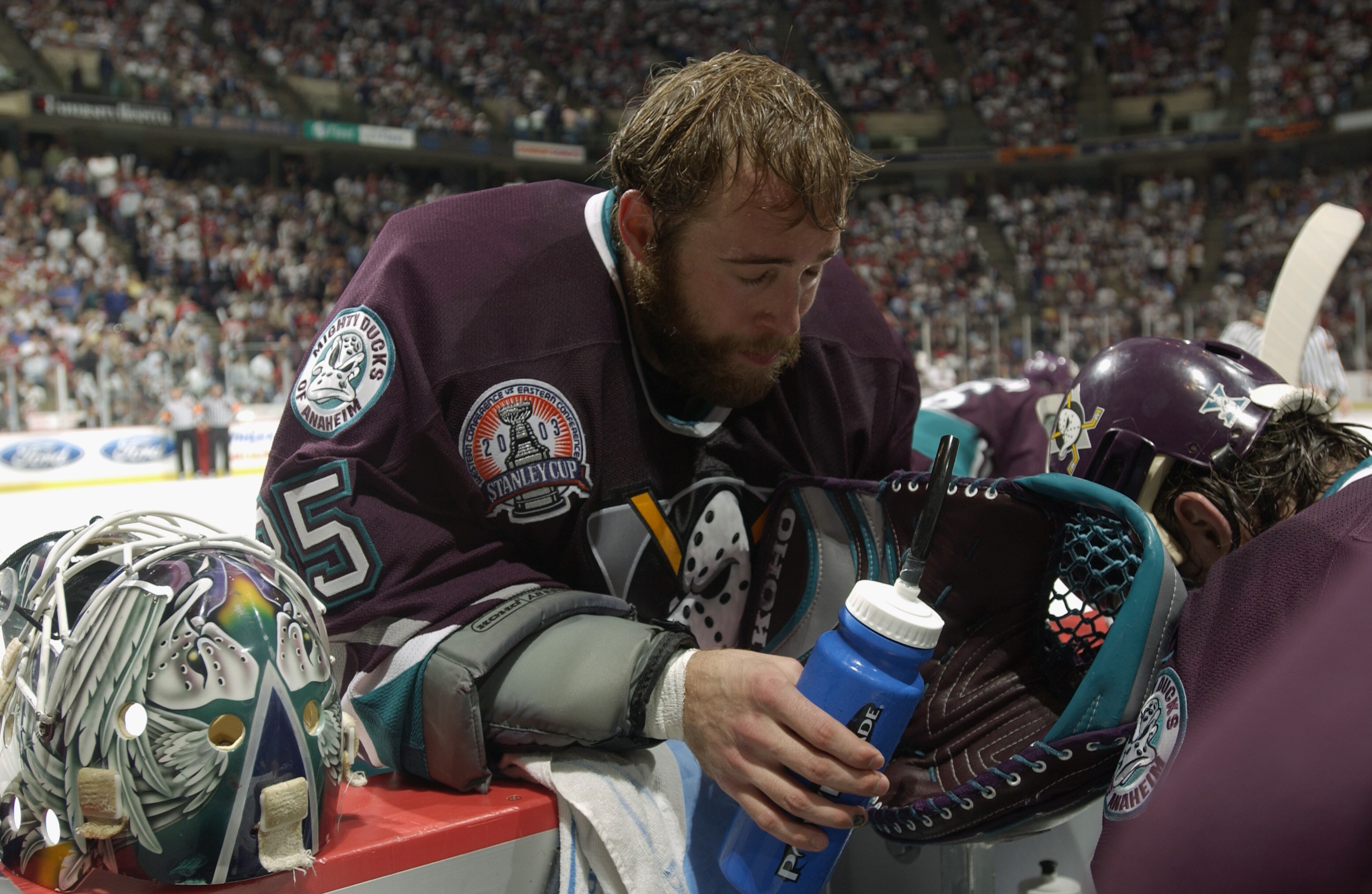 EAST RUTHERFORD, NJ - JUNE 9:  Jean-Sebastien Giguere #35 of the Mighty Ducks of Anaheim hangs his head with other teammates near the bench during a time out in game seven of the 2003 Stanley Cup Finals at Continental Airlines Arena on June 9, 2003 in Eas