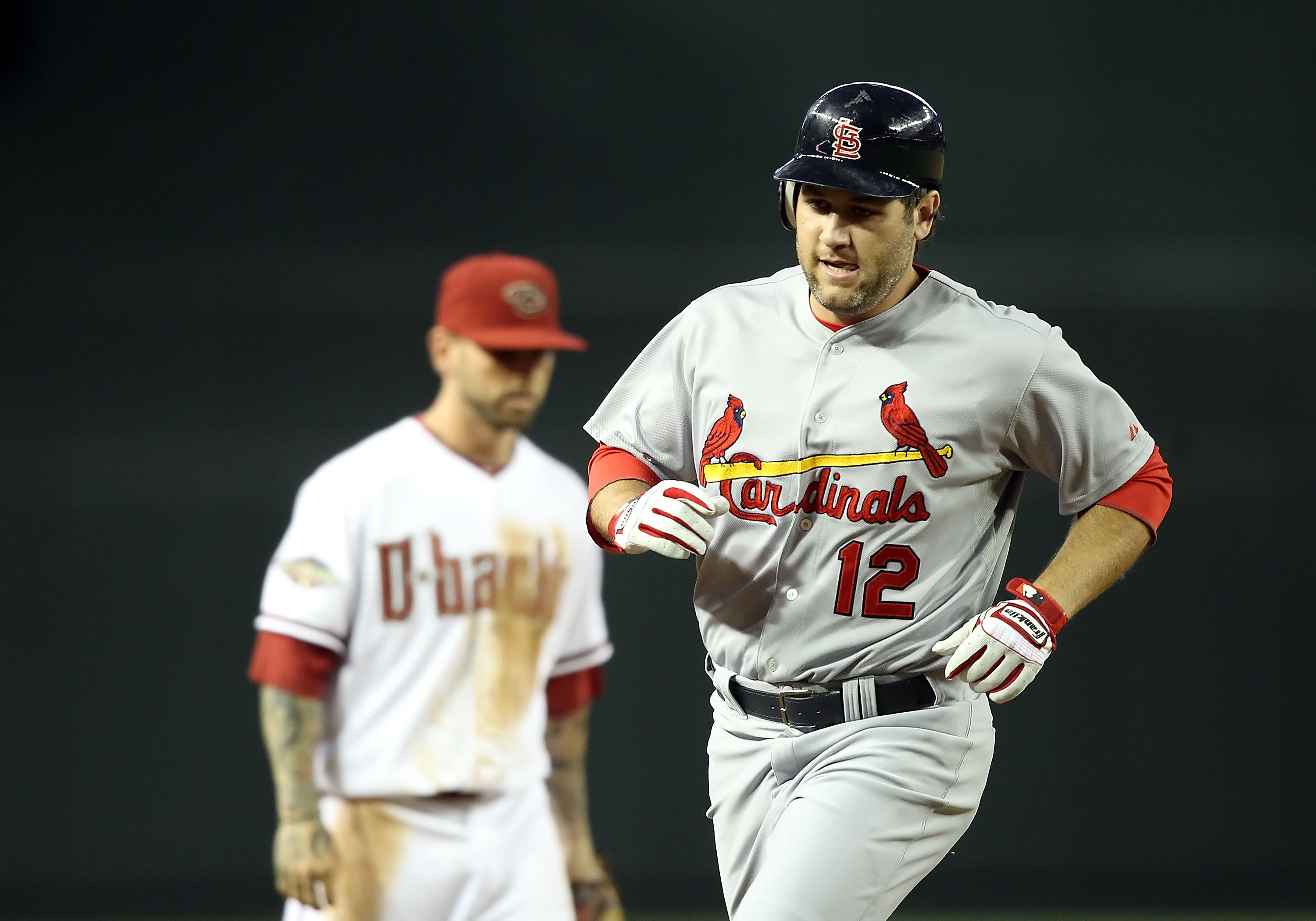 PHOENIX, AZ - APRIL 12:  Lance Berkman #12 of the St. Louis Cardinals rounds the bases after hitting a solo home run against the Arizona Diamondbacks during the second inning of the Major League Baseball game at Chase Field on April 12, 2011 in Phoenix, A