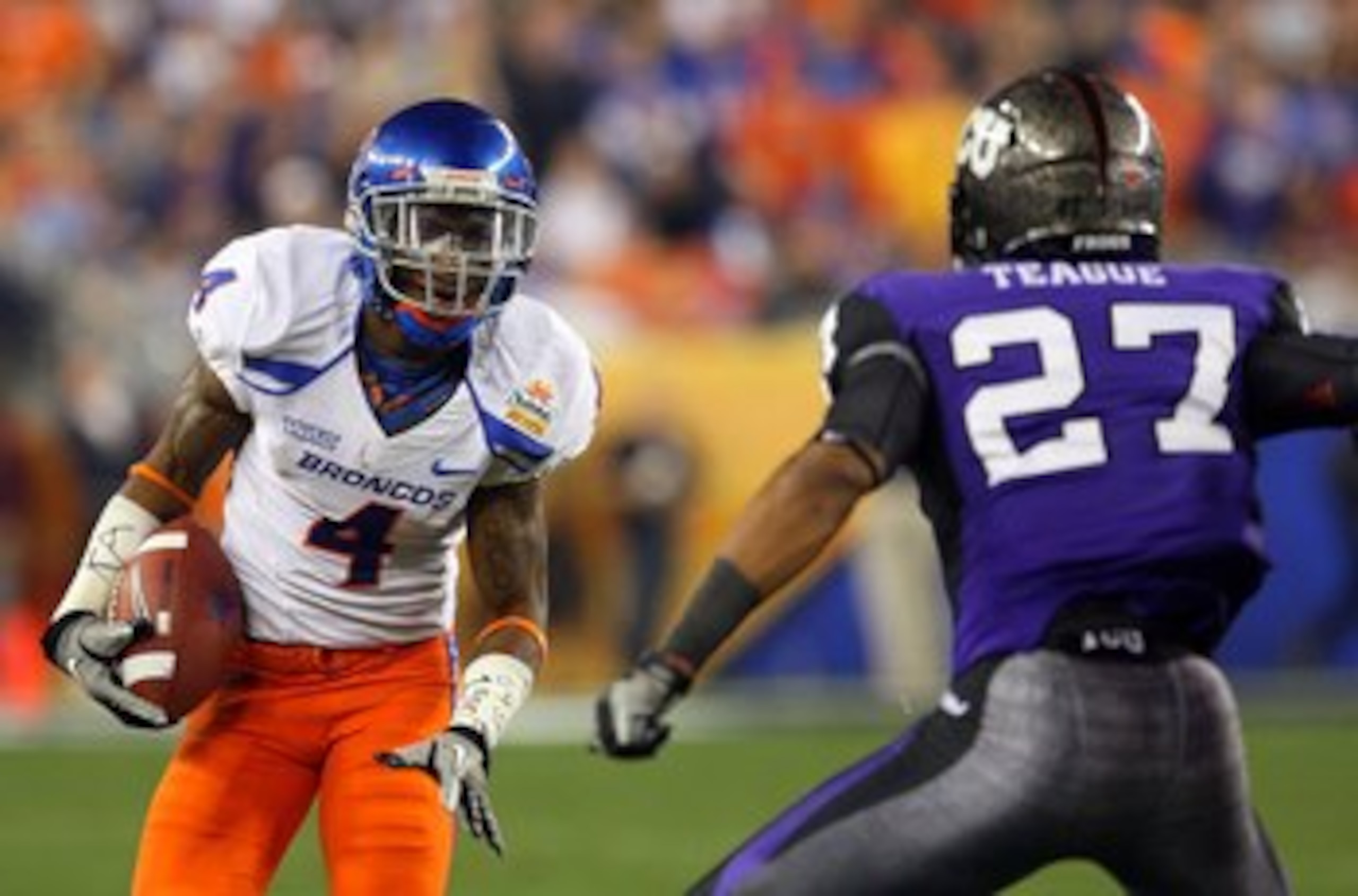 GLENDALE, AZ - JANUARY 04:  Titus Young #4 of the Boise State Broncos runs after a catch against Jason Teague #27 of the TCU Horned Frogs during the Tostitos Fiesta Bowl at the Universtity of Phoenix Stadium on January 4, 2010 in Glendale, Arizona.  (Phot