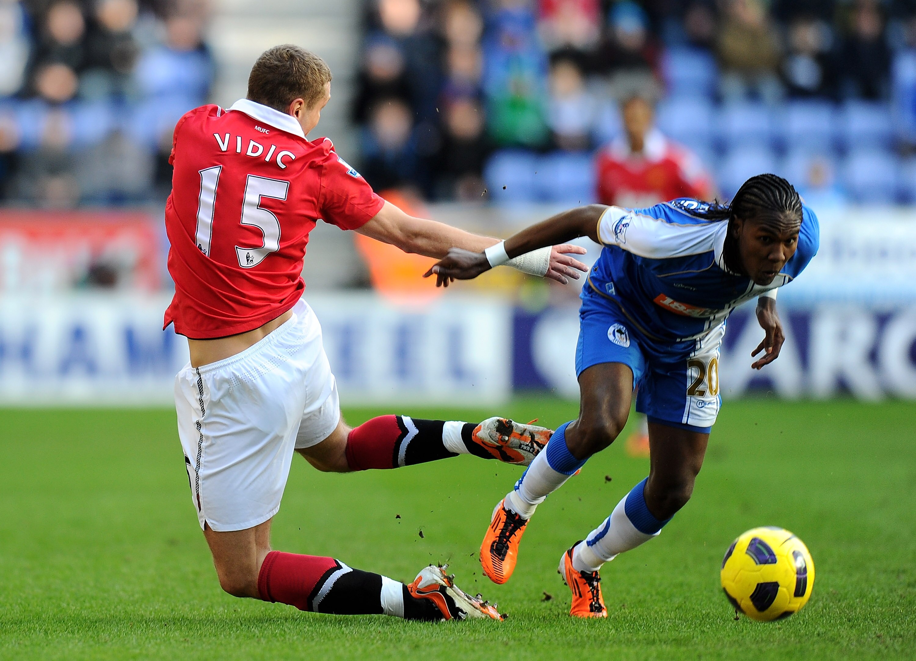 WIGAN, ENGLAND - FEBRUARY 26:  Hugo Rodallega of Wigan Athletic tangles with Nemanja Vidic of Manchester United during the Barclays Premier League match between Wigan Athletic and Manchester United at the DW Stadium on February 26, 2011 in Wigan, England.