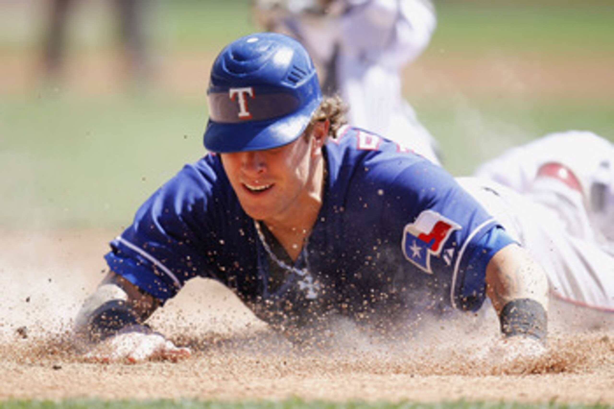 DETROIT, MI - APRIL 12:  Josh Hamilton #32 of the Texas Rangers slides into home plate during the third inning while playing the Detroit Tigers at Comerica Park on April 12, 2011 in Detroit, Michigan. Hamilton was out from a tag by Victor Martinez  (Photo