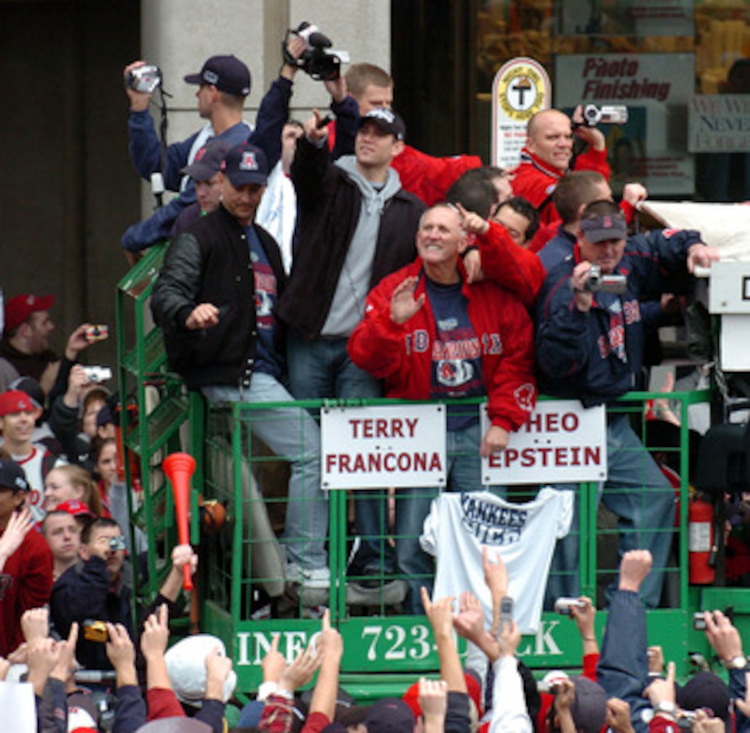 BOSTON - OCTOBER 30:  Fans cheer Boston Red Sox Manager Terry Francona and GM Theo Epstein during the Rolling Rally victory parade October 30, 2004 in Boston, Massachusetts. The Red Sox beat the St. Louis Cardinals in four straight games to take the teams