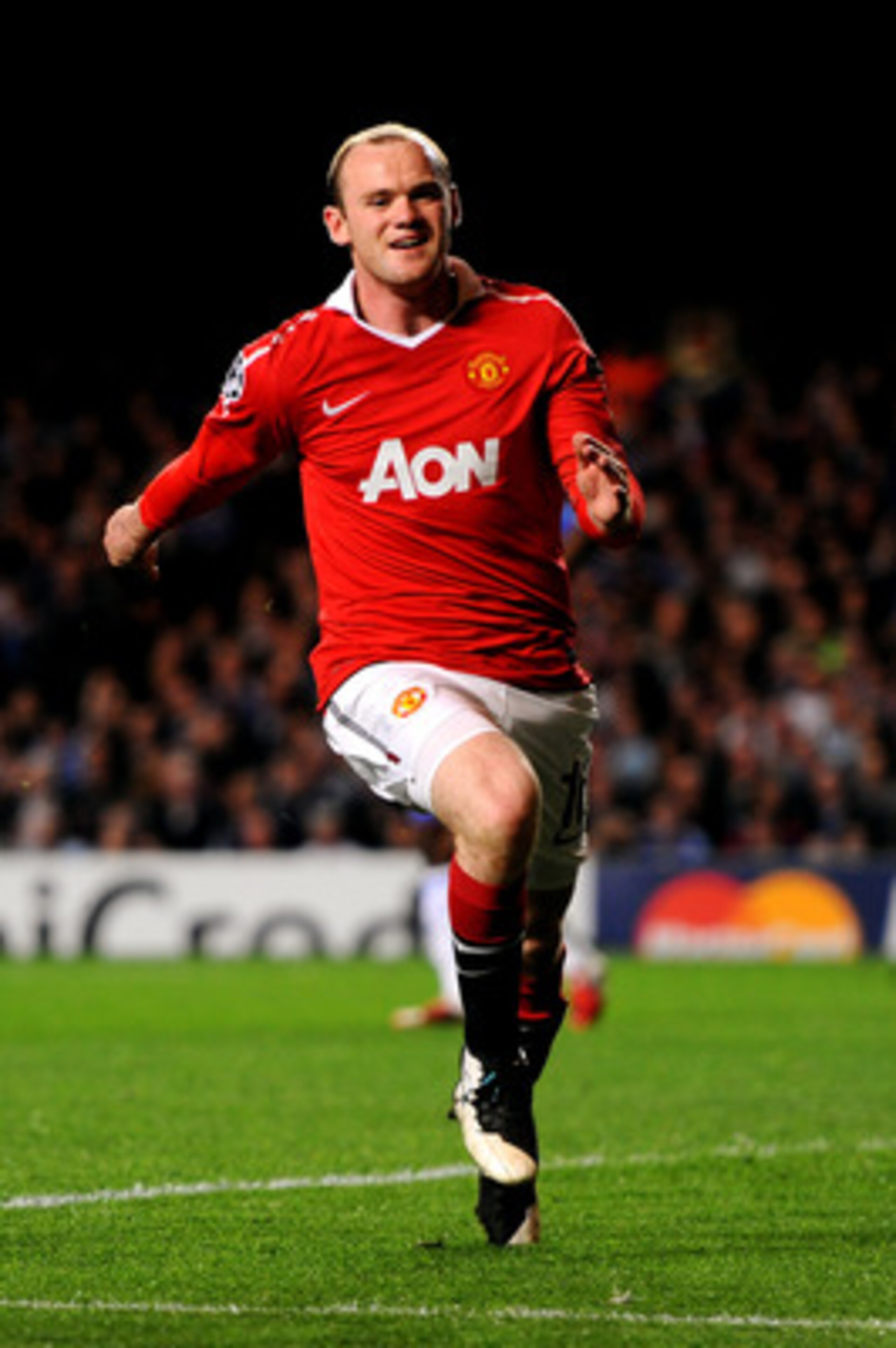 LONDON, ENGLAND - APRIL 06:  Wayne Rooney of Manchester United celebrates after scoring the opening goal during the UEFA Champions League quarter final first leg match between Chelsea and Manchester United at Stamford Bridge on April 6, 2011 in London, En