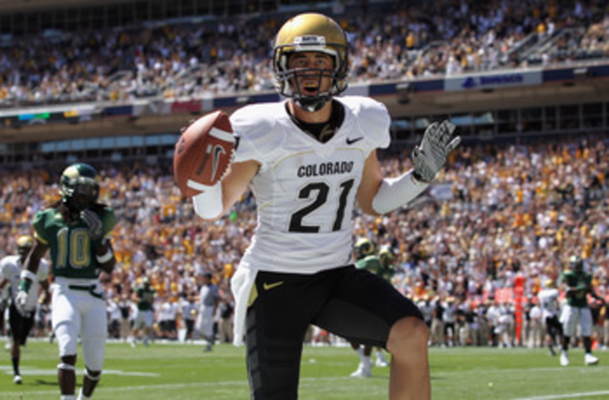 DENVER - SEPTEMBER 04:  Wide receiver Scotty McKnight #21 of the Colorado Buffaloes celebrates 27 yard touchdown reception to give the Buffs a 14-0 lead over the Colorado State Rams in the second quarter of the Rocky Mountain Showdown at INVESCO Field at 