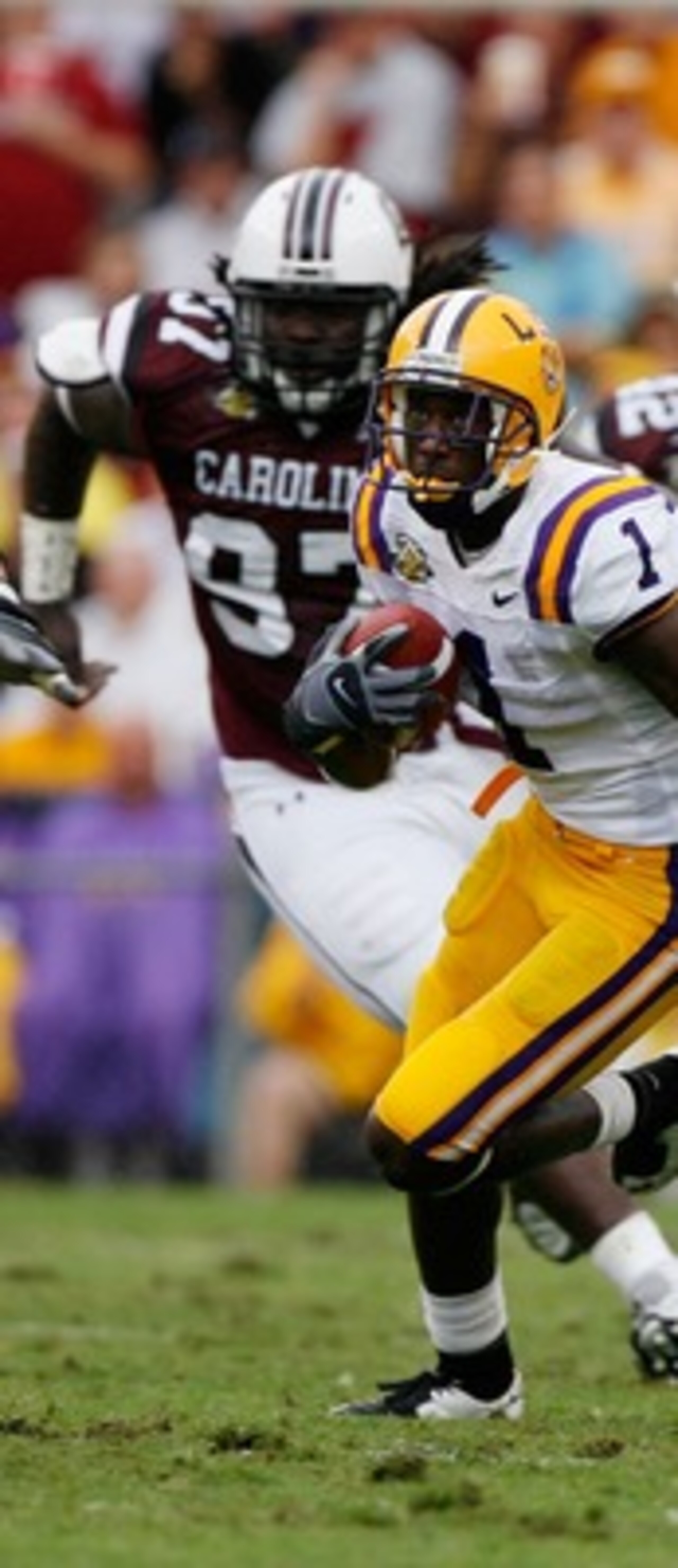 BATON ROUGE, LA - SEPTEMBER 22:  Brandon LaFell #1 of the Louisiana State University Tigers runs past Kenrick Ellis #97 and Mike Newton #42 of the South Carolina Gamecocks at Tiger Stadium September 22, 2007 in Baton Rouge, Louisiana.    (Photo by Chris G
