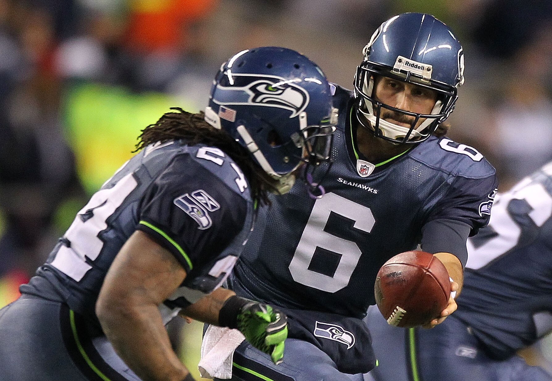 SEATTLE, WA - JANUARY 02:  Quarterback Charlie Whitehurst #6 of the Seattle Seahawks hands the ball off to running back Marshawn Lynch #24 during their game against the St. Louis Rams at Qwest Field on January 2, 2011 in Seattle, Washington.  (Photo by Ot