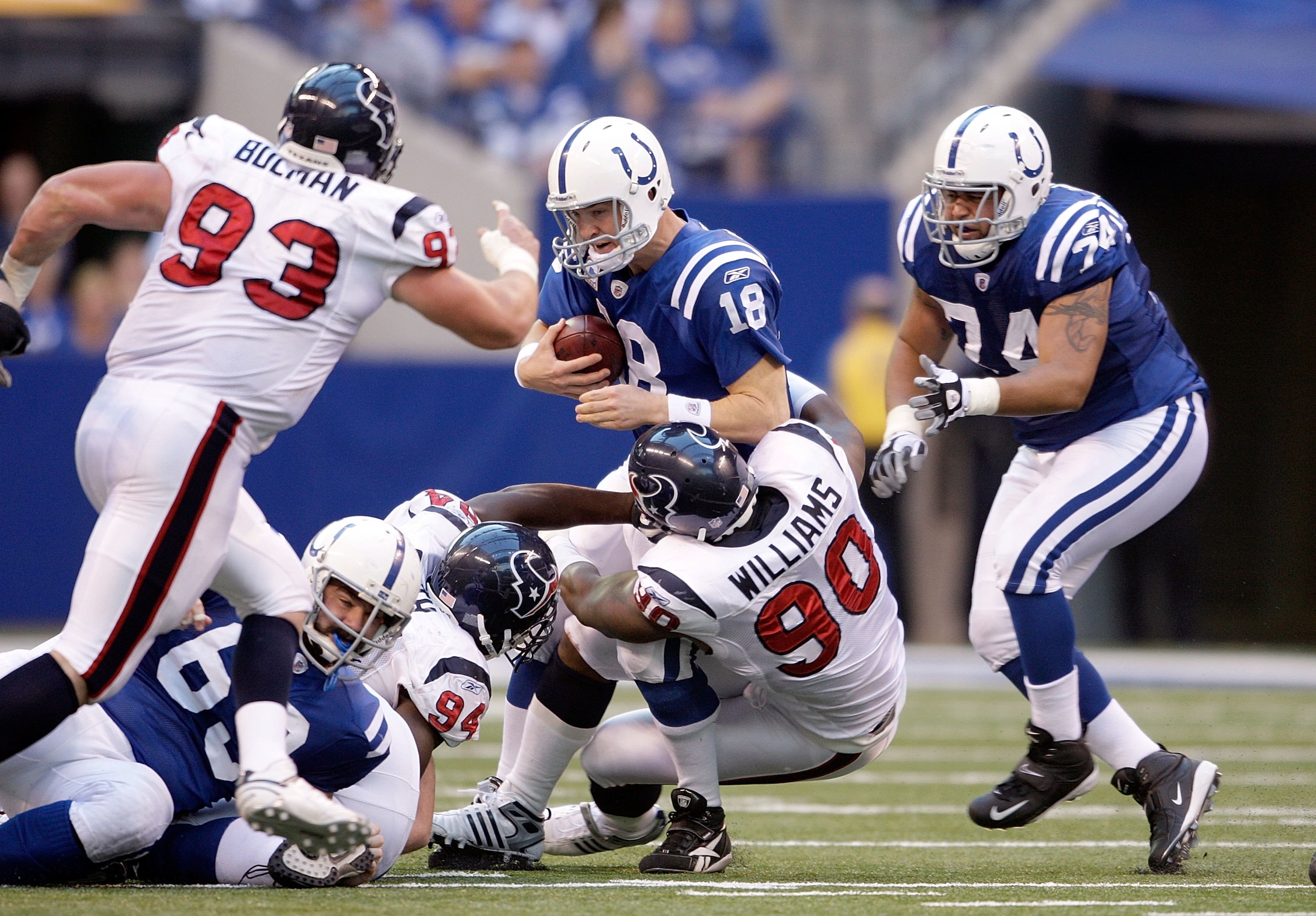 INDIANAPOLIS - NOVEMBER 8:  Peyton Manning #18 of the Indianapolis Colts is sacked by Mario Williams #90 the Houston Texans at Lucas Oil Stadium on November 8, 2009 in Indianapolis, Indiana.  The Colts defeated the Texans 20-17.  (Photo by Andy Lyons/Gett