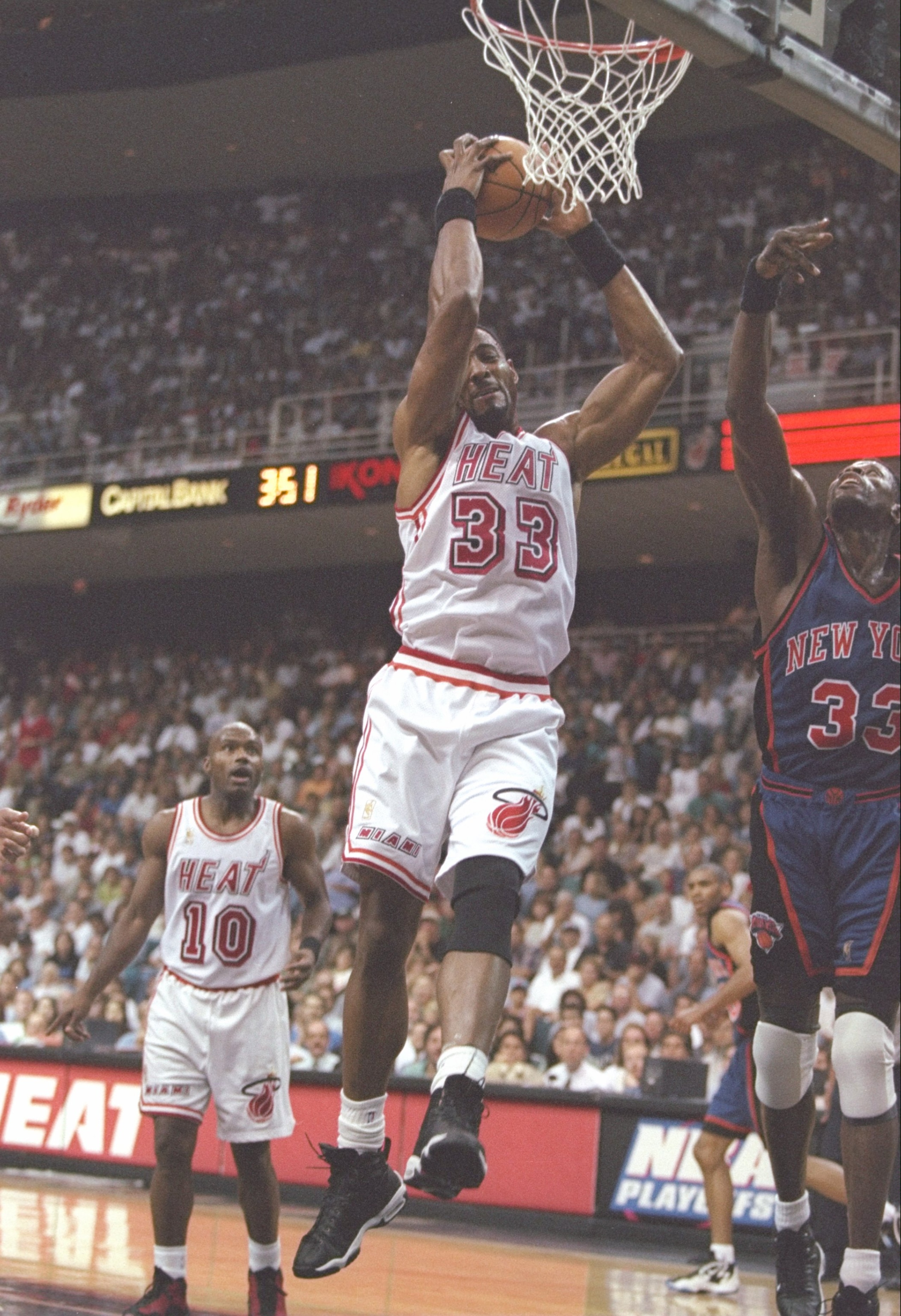 18 May 1997:  Guard Tim Hardaway of the Miami Heat watches as center Alonzo Mourning of the Miami Heat and center Patrick Ewing of the New York Knicks jump for the ball during a playoff game at the Miami Arena in Miami, Florida.  The Heat won the game 101