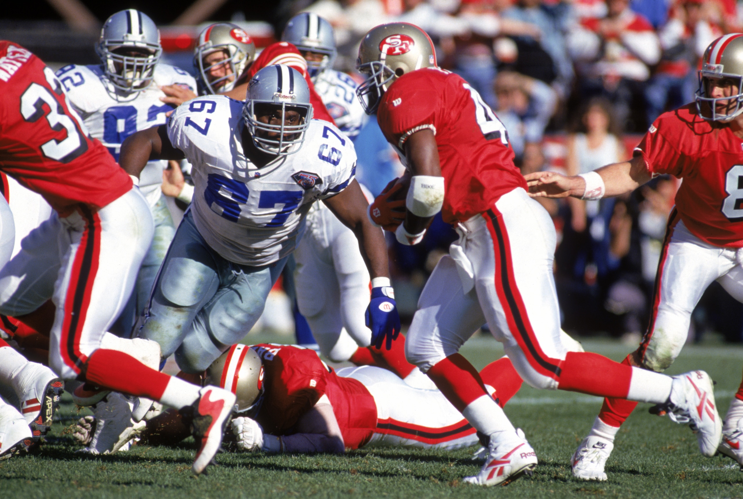 SAN FRANCISCO - NOVEMBER 13:  Defensive back Russell Maryland #67 of the Dallas Cowboys goes after full back William Floyd #40 of the San Francisco 49ers during a game at Candlestick Park on November 13, 1994 in San Francisco, California.  The 49ers won 2