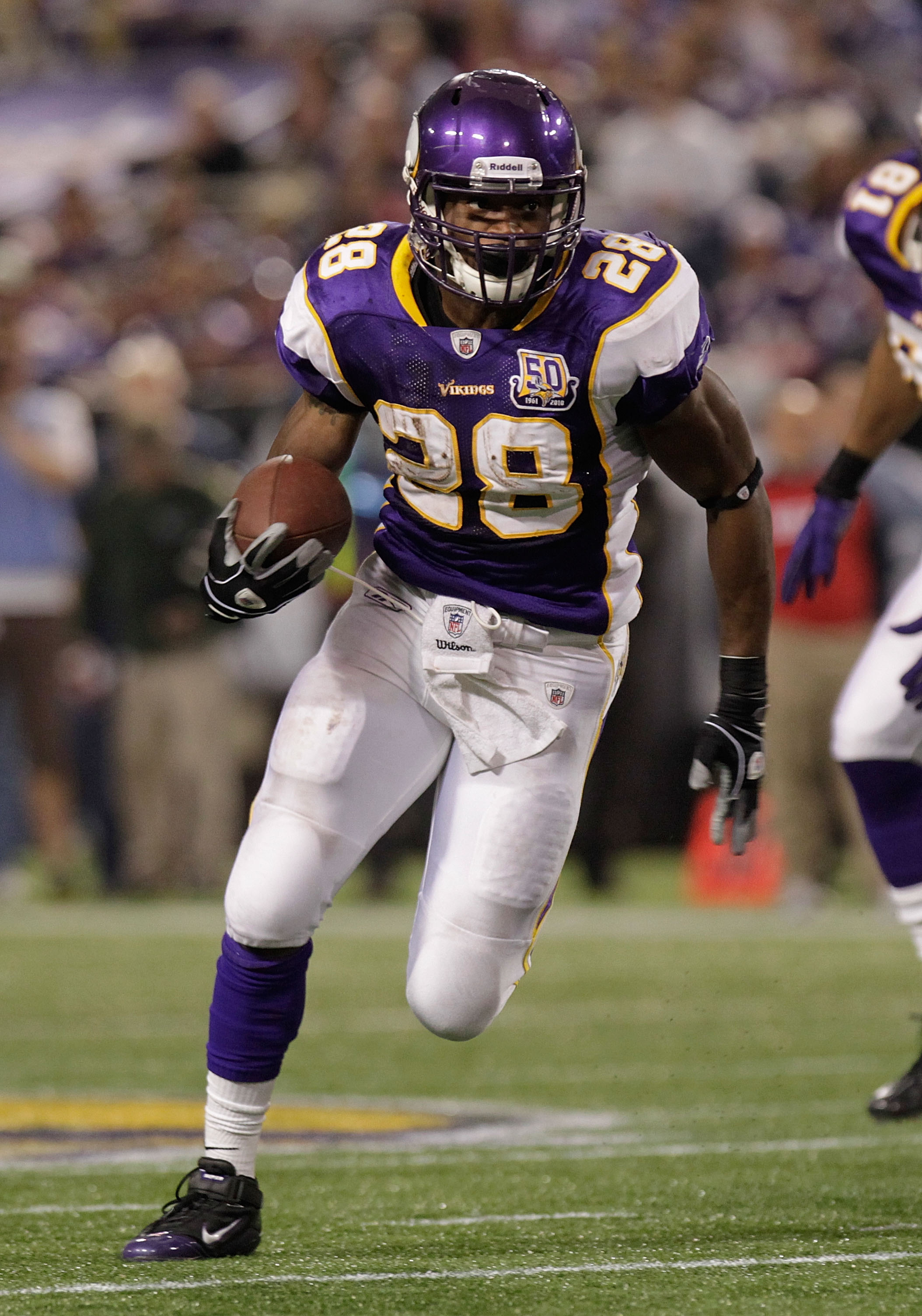 MINNEAPOLIS, MN - DECEMBER 05:  Adrian Peterson #28 of the Minnesota Vikings rushes against  the Buffalo Bills at the Mall of America Field at the Hubert H. Humphrey Metrodome on December 5, 2010 in Minneapolis, Minnesota.  (Photo by Nick Laham/Getty Imag