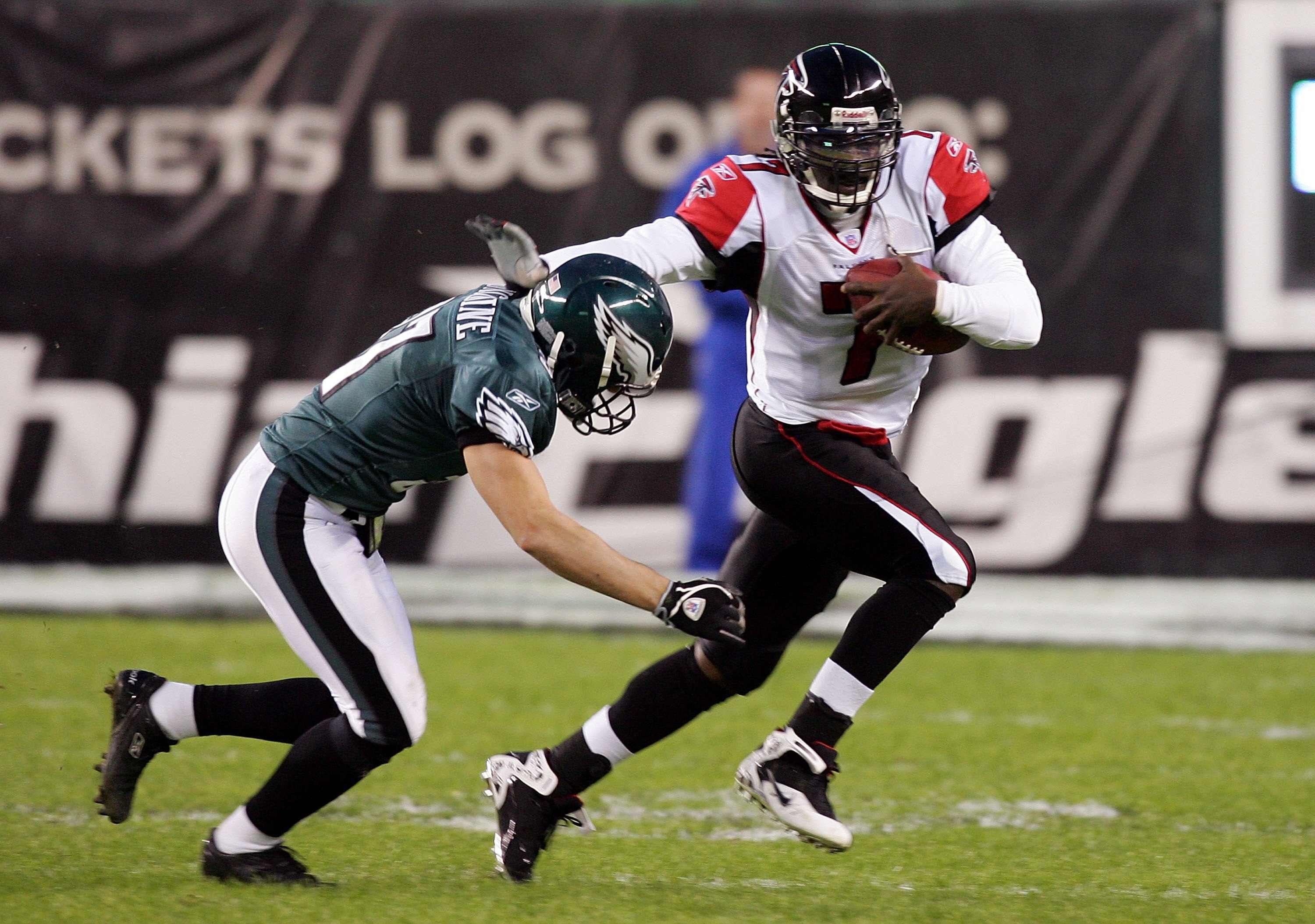 PHILADELPHIA - DECEMBER 31: Michael Vick #7 of the Atlanta Falcons runs the ball against Sean Considine #37 of the Philadelphia Eagles in NFL action December 31, 2006 at Lincoln Financial Field in Philadelphia, Pennsylvania.  (Photo by Jim McIsaac/Getty I
