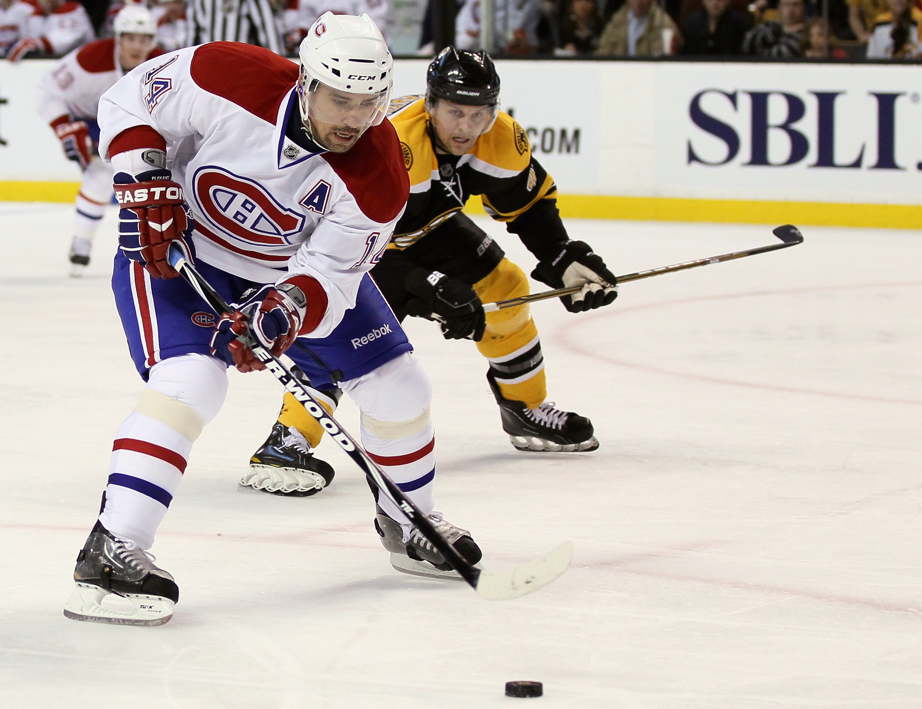 BOSTON, MA - APRIL 14:  Tomas Plekanec #14 of the Montreal Canadiens heads for net as Dennis Seidenberg #44 of the Boston Bruins defends  in Game One of the Eastern Conference Quarterfinals during the 2011 NHL Stanley Cup Playoffs at TD Garden on April 14
