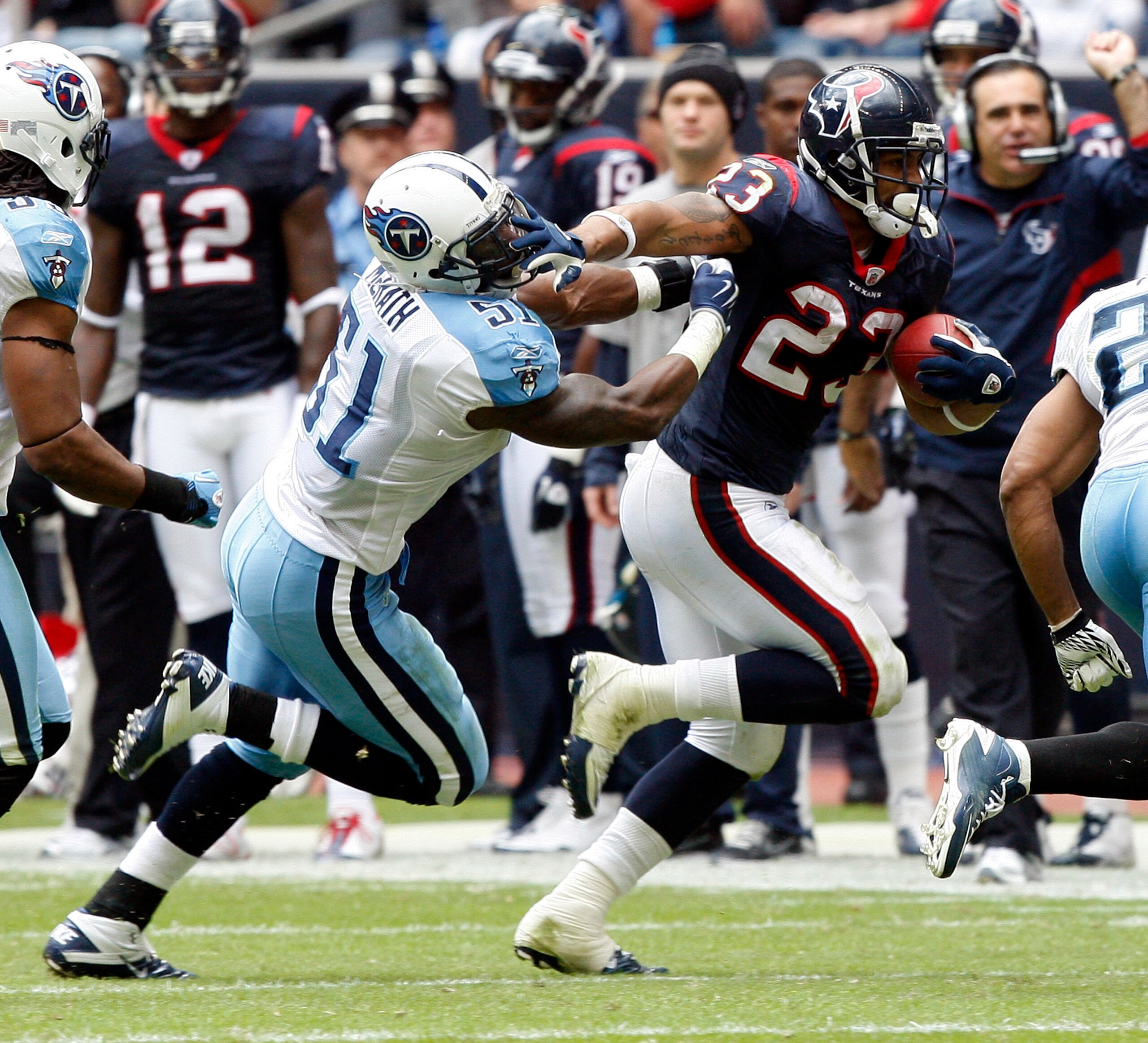 HOUSTON - NOVEMBER 28:  Running back Arian Foster #23 of the Houston Texans gives linebacker Gerlad McRath #51 of the Tennessee Titans a stiff arm to the face as he rushes in the second quarter at Reliant Stadium on November 28, 2010 in Houston, Texas.  (