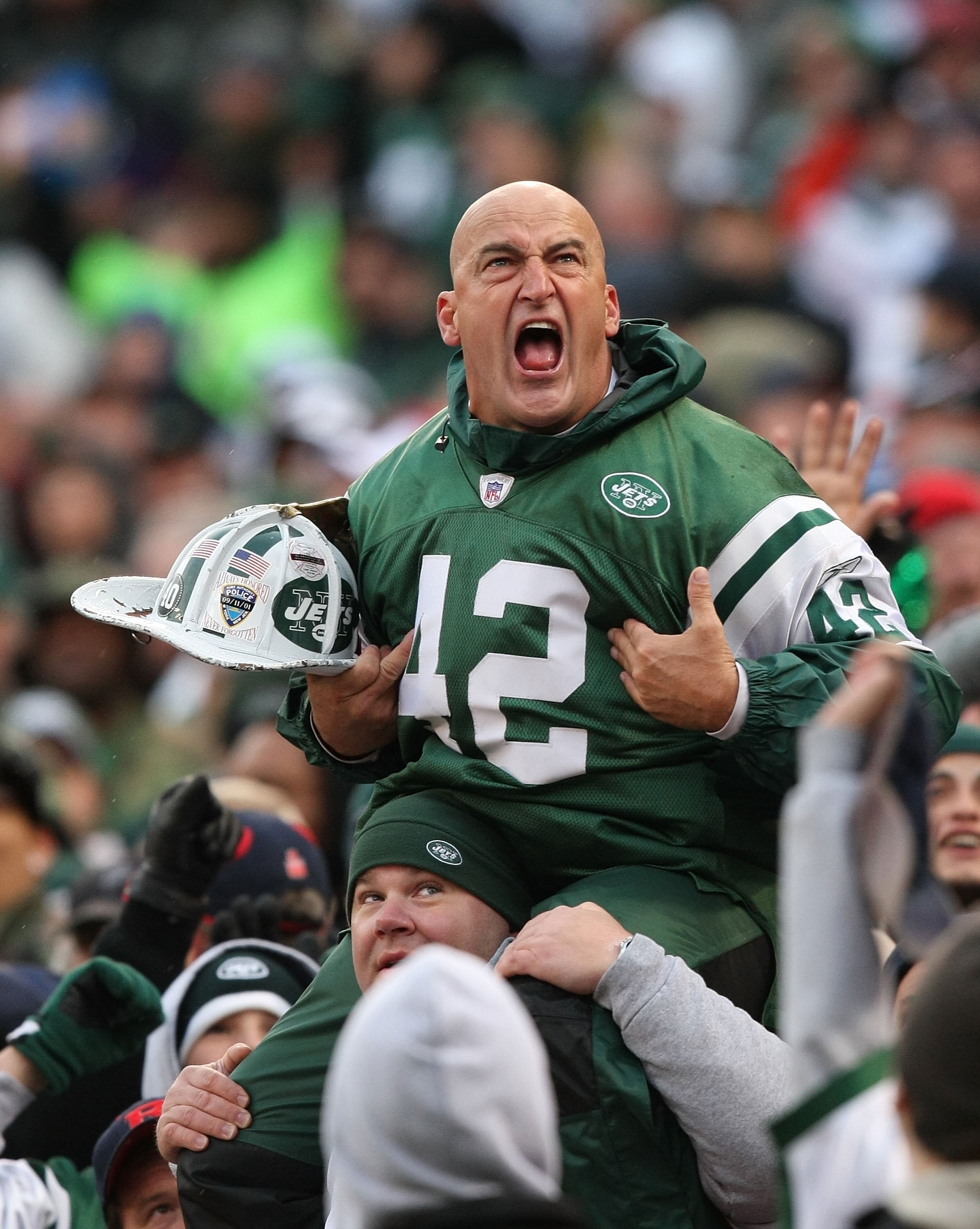 EAST RUTHERFORD, NJ - OCTOBER 18:  New York Jets fan fireman Ed Anzalone cheers during the game between The New York Jets against The Buffalo Bills on October 18, 2009 at Giants Stadium in East Rutherford, New Jersey.  (Photo by Al Bello/Getty Images)