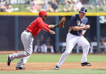 PEORIA, AZ - MARCH 15:  Infielder Erick Aybar #2 of the Los Angeles Angels of Anaheim tags out Brad Hawpe #11 of the San Diego Padres during the third inning of the spring training game at Peoria Stadium on March 15, 2011 in Peoria, Arizona.  (Photo by Ch