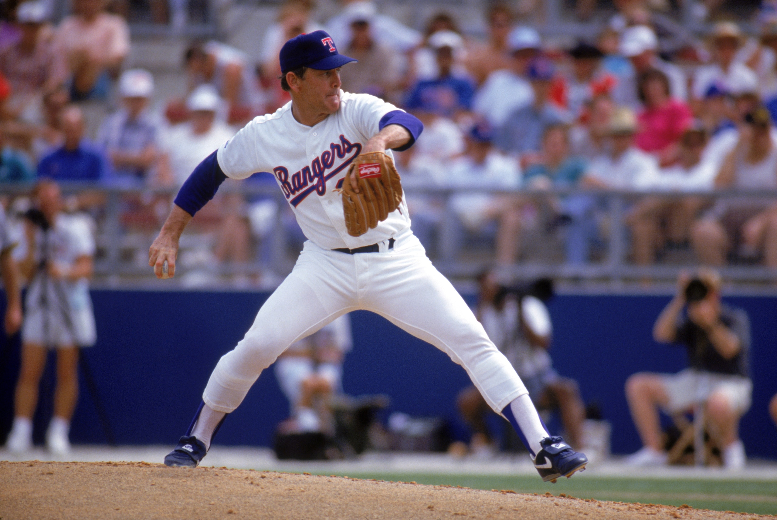 ARLINGTON, TX - 1990s:  Nolan Ryan #34 of the Texas Rangers pitches during a circa 1990s game at Arlington Stadium in Arlington, Texas. Ryan pitched for the Rangers from 1989-93.  (Photo by Jonathan Daniel/Getty Images)
