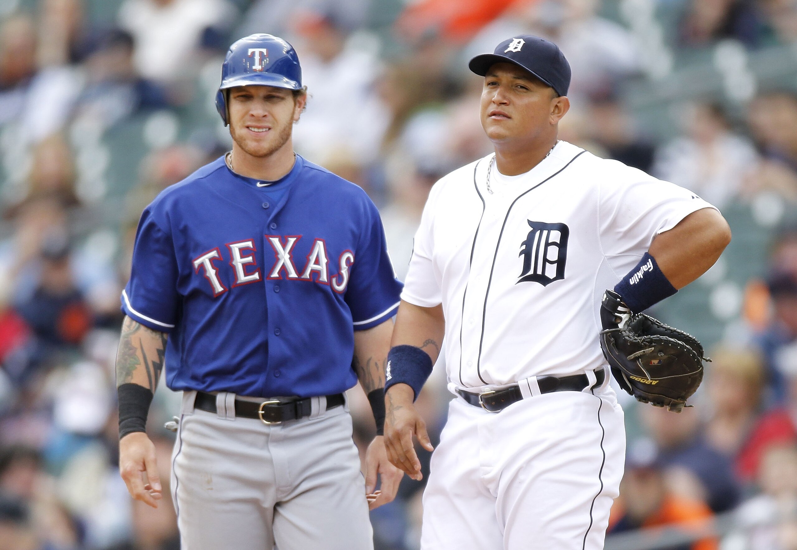 DETROIT, MI - APRIL 11:  Miguel Cabrera #24 of the Detroit Tigers stands on first base with Josh Hamilton #32 of the Texas Rangers during the seventh inning at Comerica Park on April 11, 2011 in Detroit, Michigan. Texas won the game 2-0.  (Photo by Gregor
