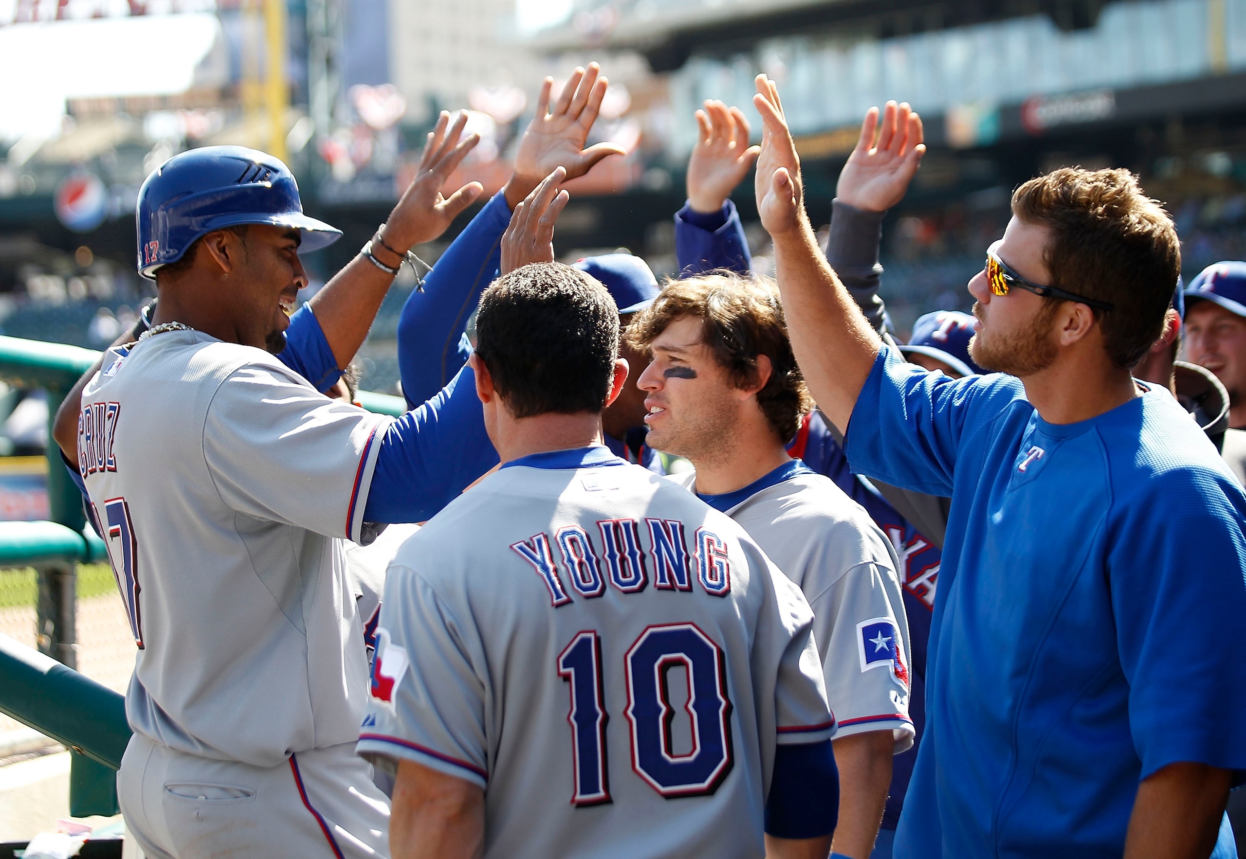 DETROIT - APRIL 13: Nelson Cruz #17 of the Texas Rangers is congratulated by his teamates after scoring in the sixth inning of the game at Comerica Park on April 13, 2011 in Detroit, Michigan. The Tigers defeated the Rangers 3-2.  (Photo by Leon Halip/Get