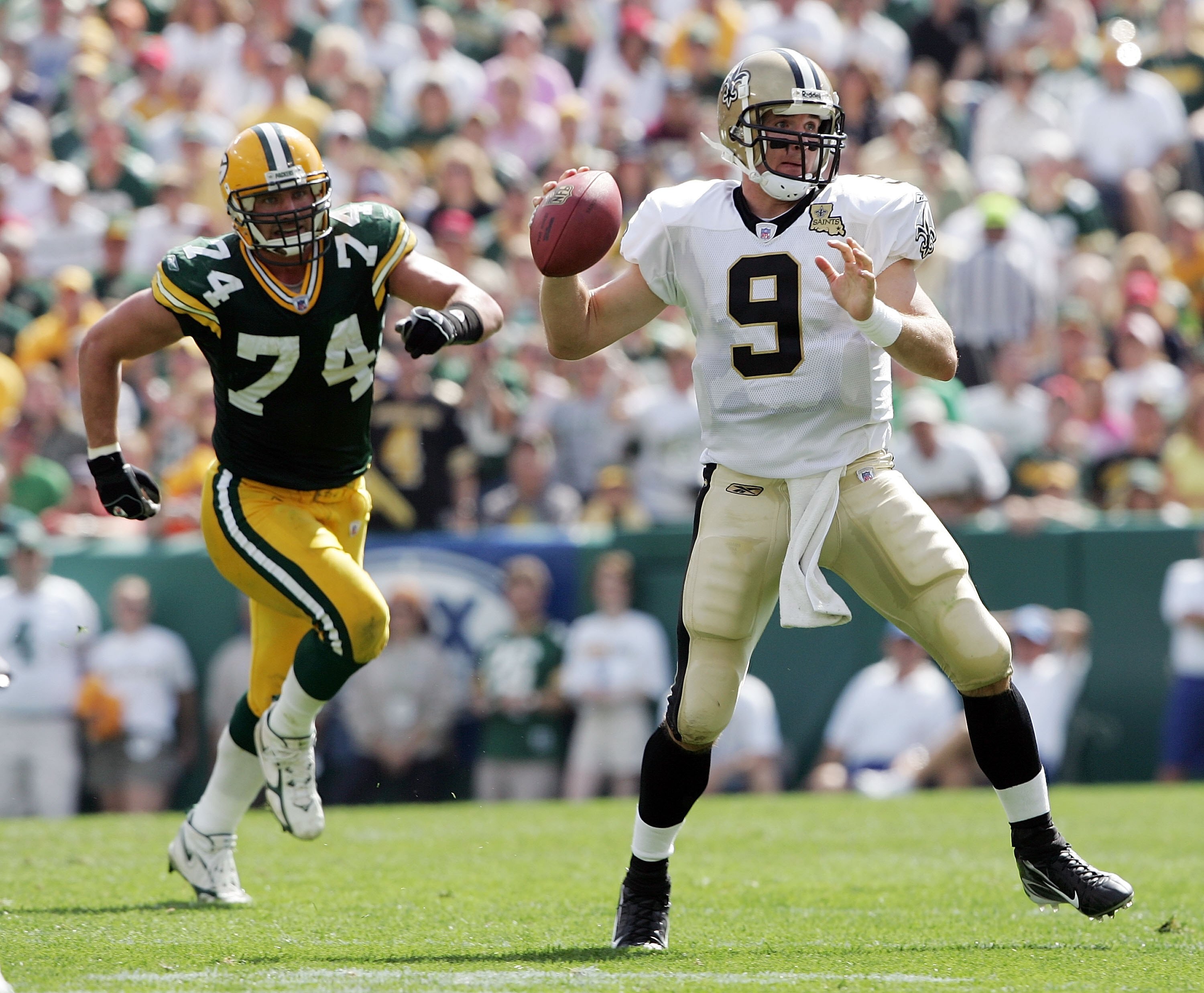 GREEN BAY, WI - SEPTEMBER 17:  Drew Brees #9 of the New Orleans Saints is chased by Aaron Kampman #74 of the Green Bay Packers on September 17, 2006 at Lambeau Field in Green Bay, Wisconsin. The New Orleans Saints defeated the Green Bay Packers 34-27.  (P