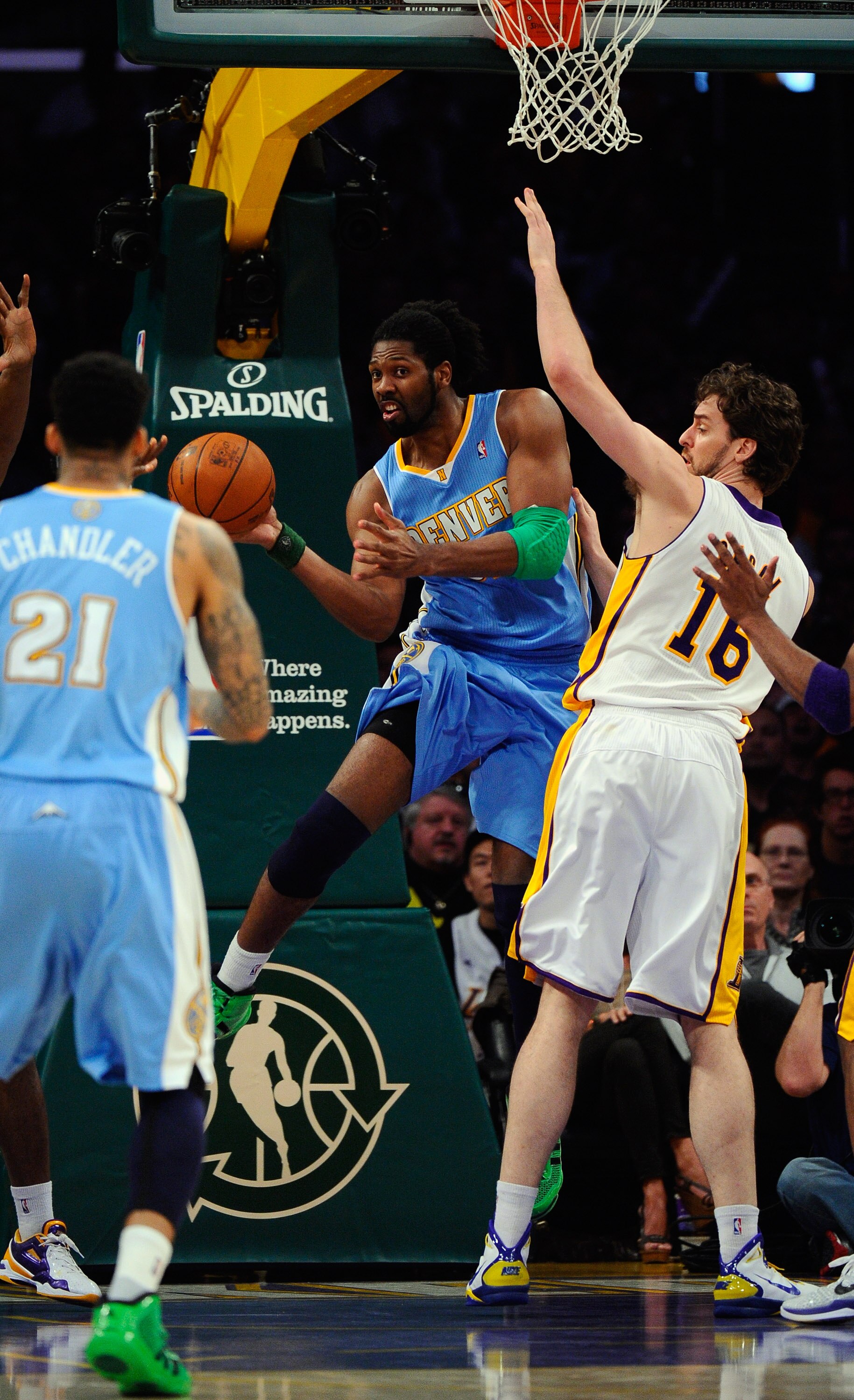 LOS ANGELES, CA - APRIL 03:  Nene #31 of the Denver Nuggets looks for an outlet pass against Pau Gasol #16 of the Los Angeles Lakers at Staples Center on April 3, 2011 in Los Angeles, California. NOTE TO USER: User expressly acknowledges and agrees that, 