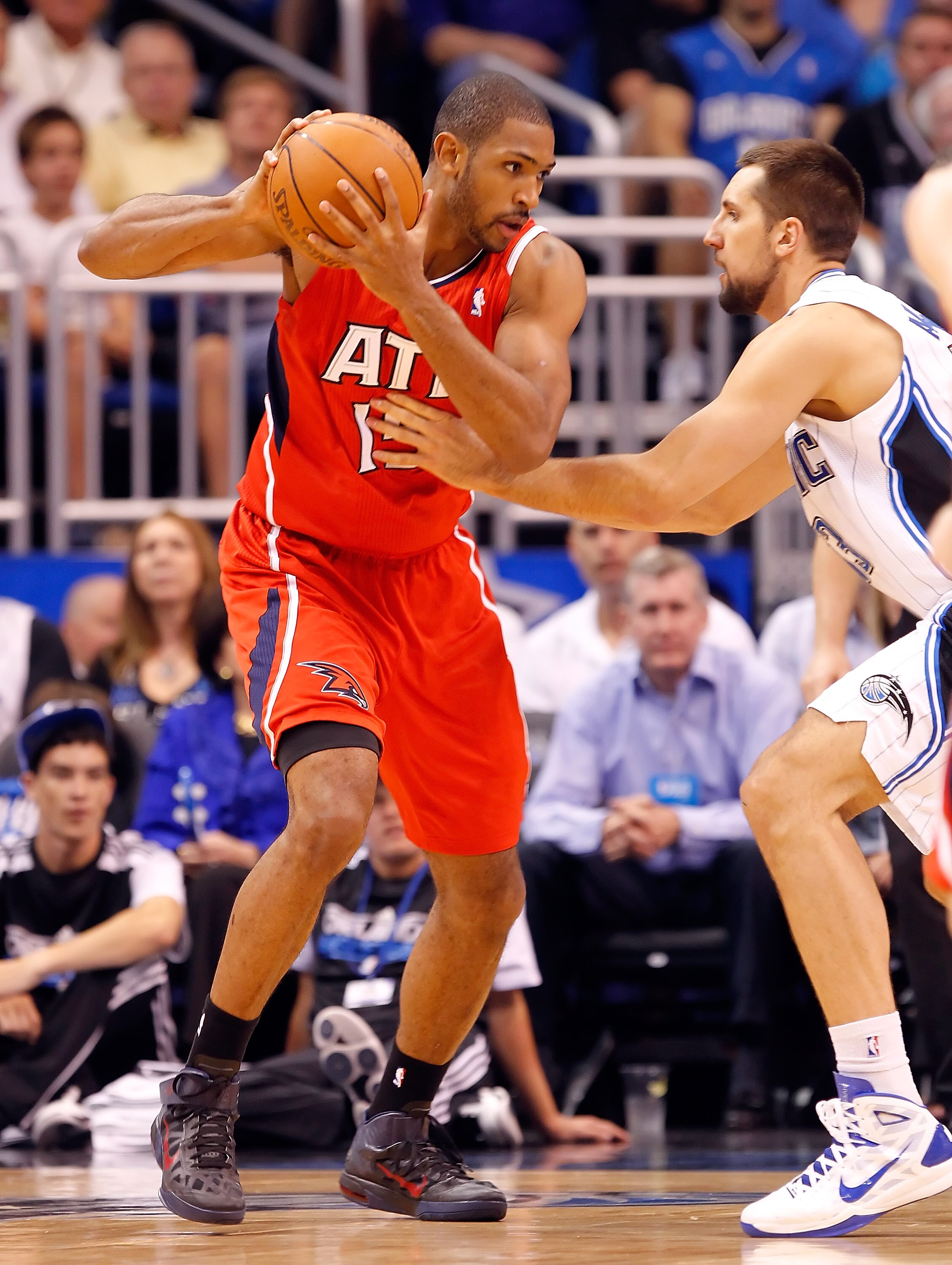 ORLANDO, FL - APRIL 16:  Al Horford #15 of the Atlanta Hawks looks to pass the ball as Ryan Anderson #33 of the Orlando Magic defends during Game One of the Eastern Conference Quarterfinals of the 2011 NBA Playoffs on April 16, 2011 at the Amway Arena in