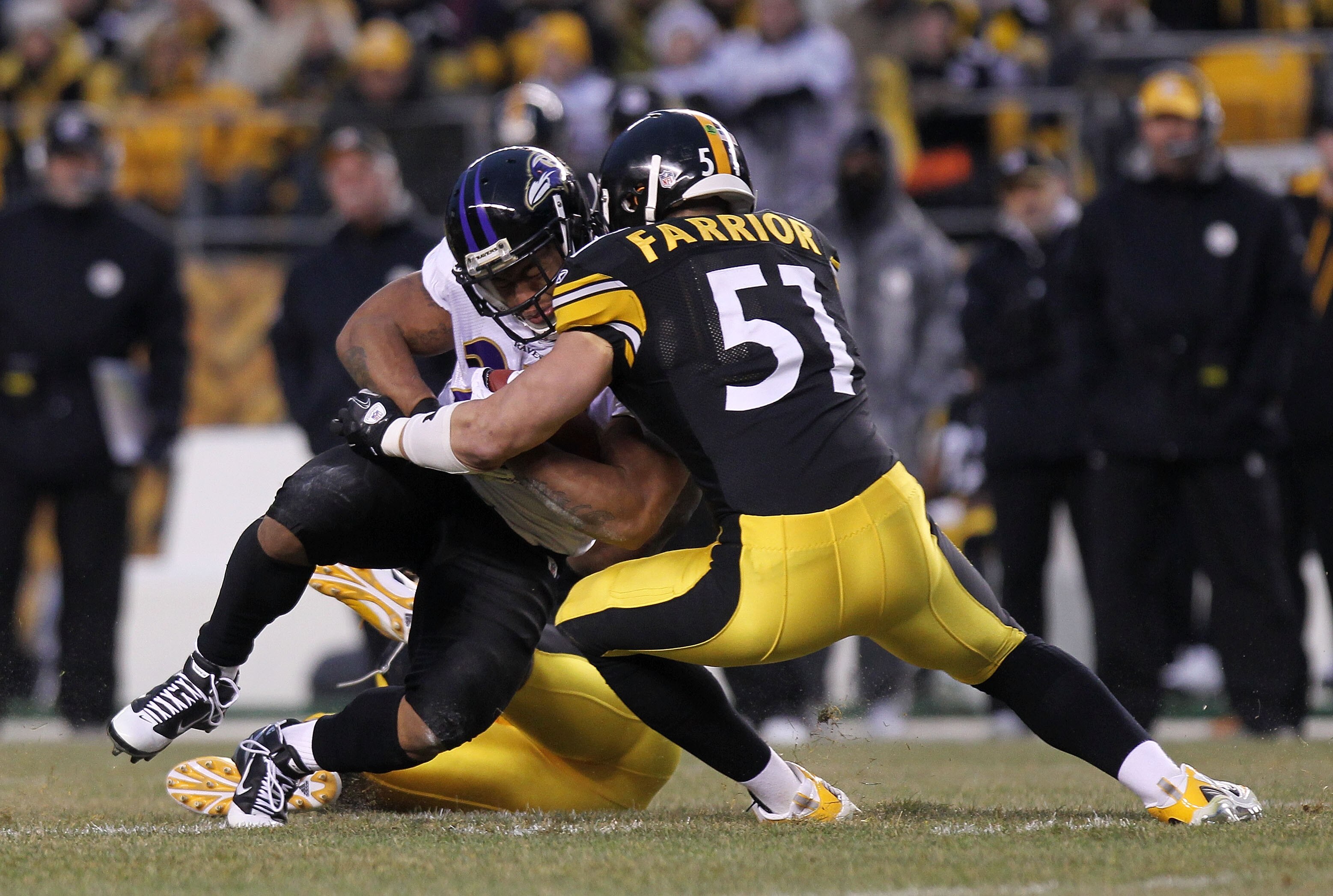 PITTSBURGH, PA - JANUARY 15:  Running back Ray Rice #27 of the Baltimore Ravens is hit by linebacker James Farrior #51 of the Pittsburgh Steelers in the first quarter of the AFC Divisional Playoff Game at Heinz Field on January 15, 2011 in Pittsburgh, Pen