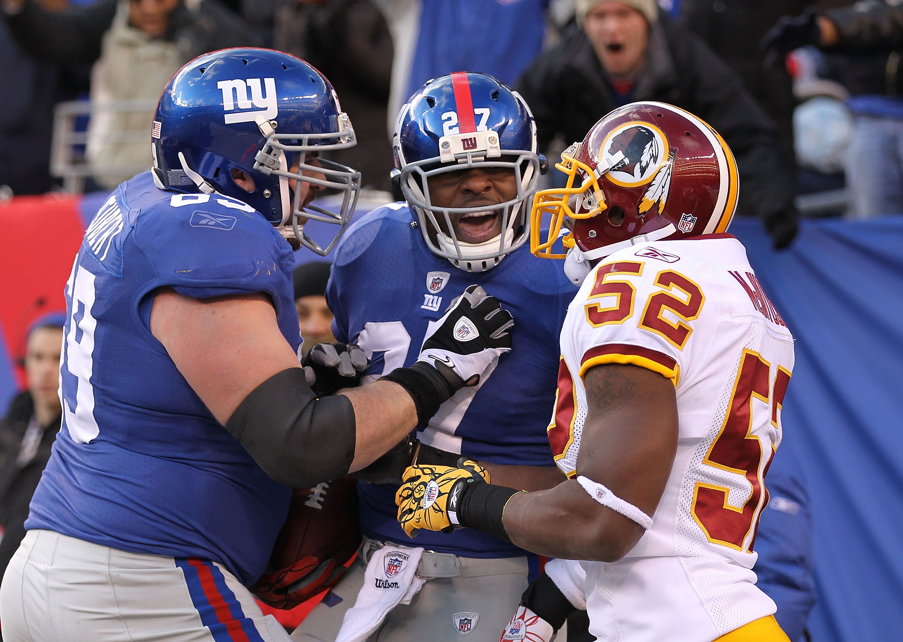 EAST RUTHERFORD, NJ - DECEMBER 05:  Brandon Jacobs #27 of the New York Giants has words with Rocky McIntosh #52 of the Washington Redskins after Jacobs scored a touchdown during their game on December 5, 2010 at The New Meadowlands Stadium in East Rutherf