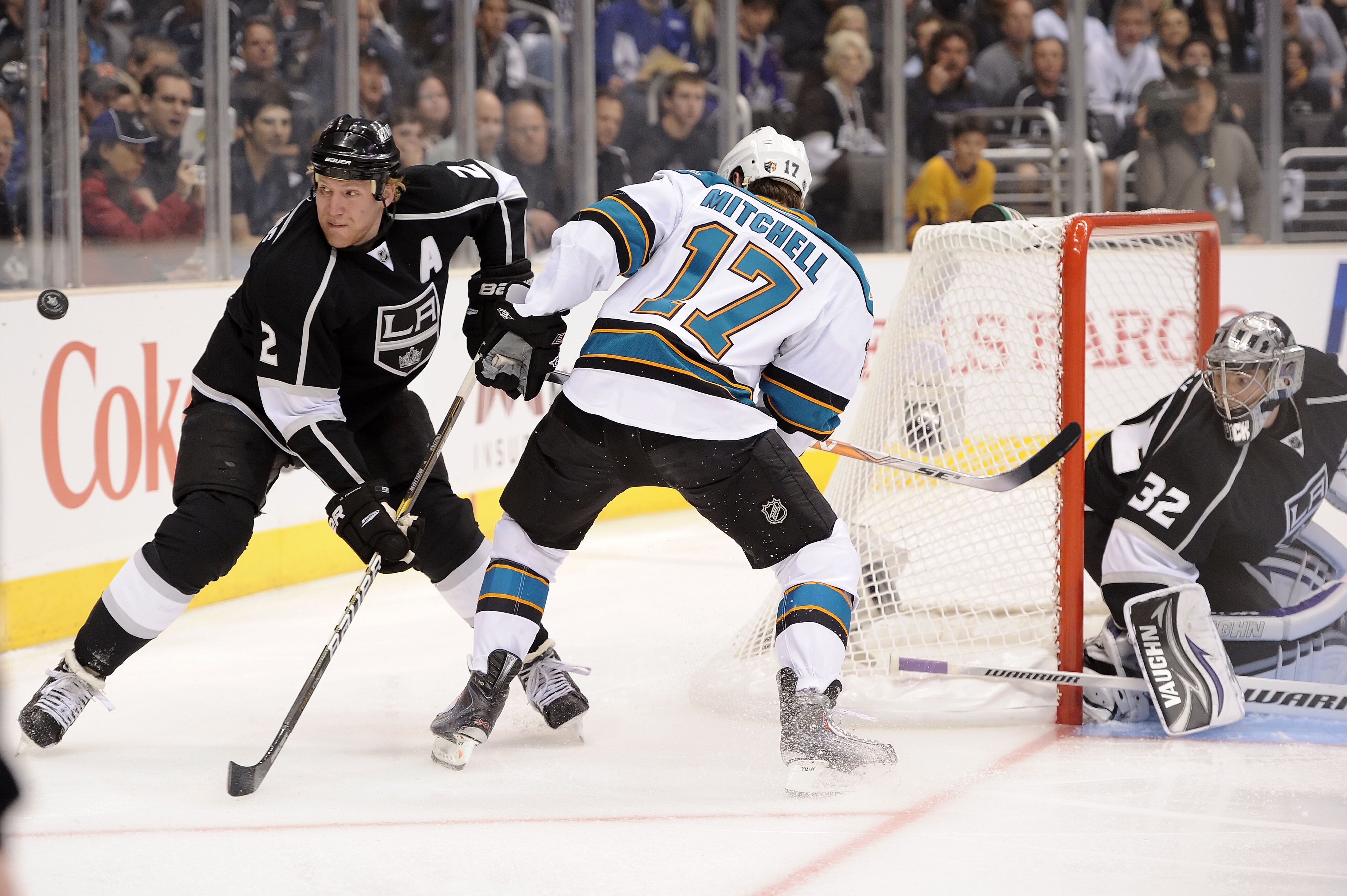 LOS ANGELES, CA - APRIL 19:  Matt Greene #2 of the Los Angeles Kings fights for possesion of the puck with Torrey Mitchell #17 of the San Jose Sharks in the first period of game three of the Western Conference Quarterfinals during the 2011 NHL Stanley Cup