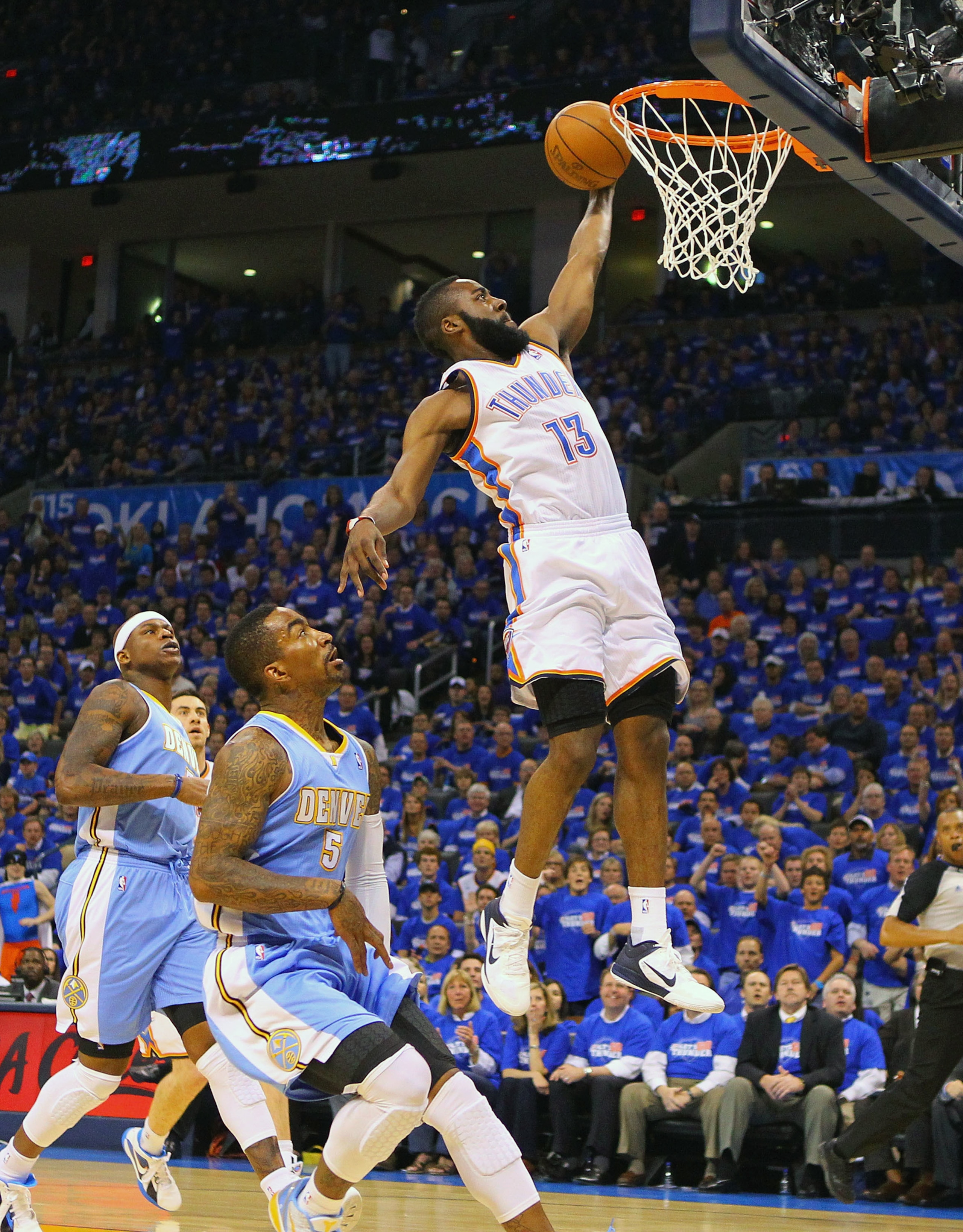 OKLAHOMA CITY, OK - APRIL 20: James Harden #13 of the Oklahoma City Thunder dunks the ball against J.R. Smith #5 of the Denver Nuggets in Game Two of the Western Conference Quarterfinals in the 2011 NBA Playoffs on April 20, 2011 at the Ford Center in Okl