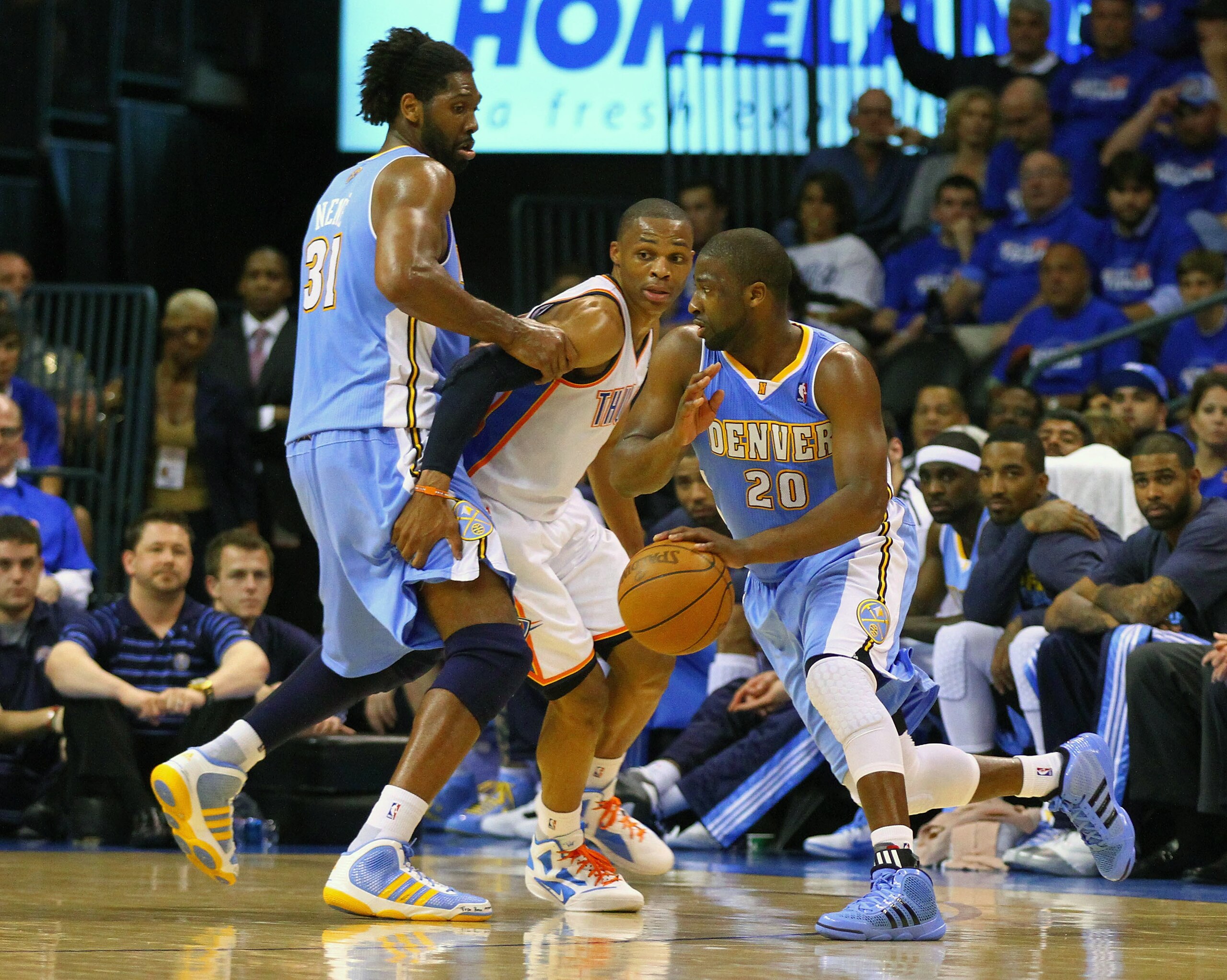 OKLAHOMA CITY, OK - APRIL 20: Raymond Felton #20 of the Denver Nuggets drives to the basket as Nene Hilario #31 also of the Denver Nuggets defends against Russell Westbrook #0 of the Oklahoma City Thunder in Game Two of the Western Conference Quarterfinal