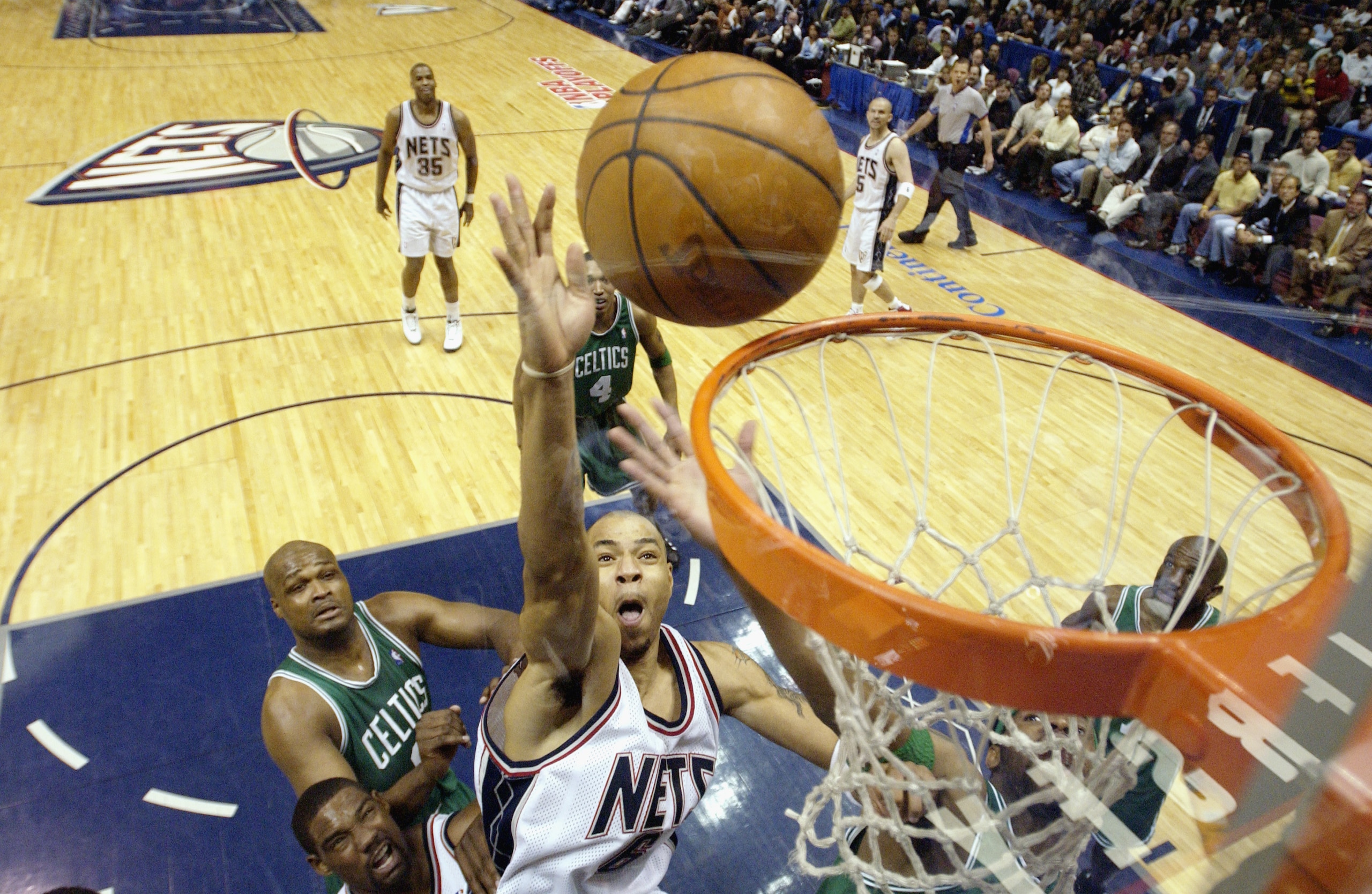 EAST RUTHERFORD, NJ - MAY 7:  Kenyon Martin #6 of the New Jersey Nets shoots past Antoine Walker #8 of the Boston Celtics in Game two of the Eastern Conference Semifinals during the 2003 NBA Playoffs on May 7, 2003 at Continental Airlines Arena in East Ru