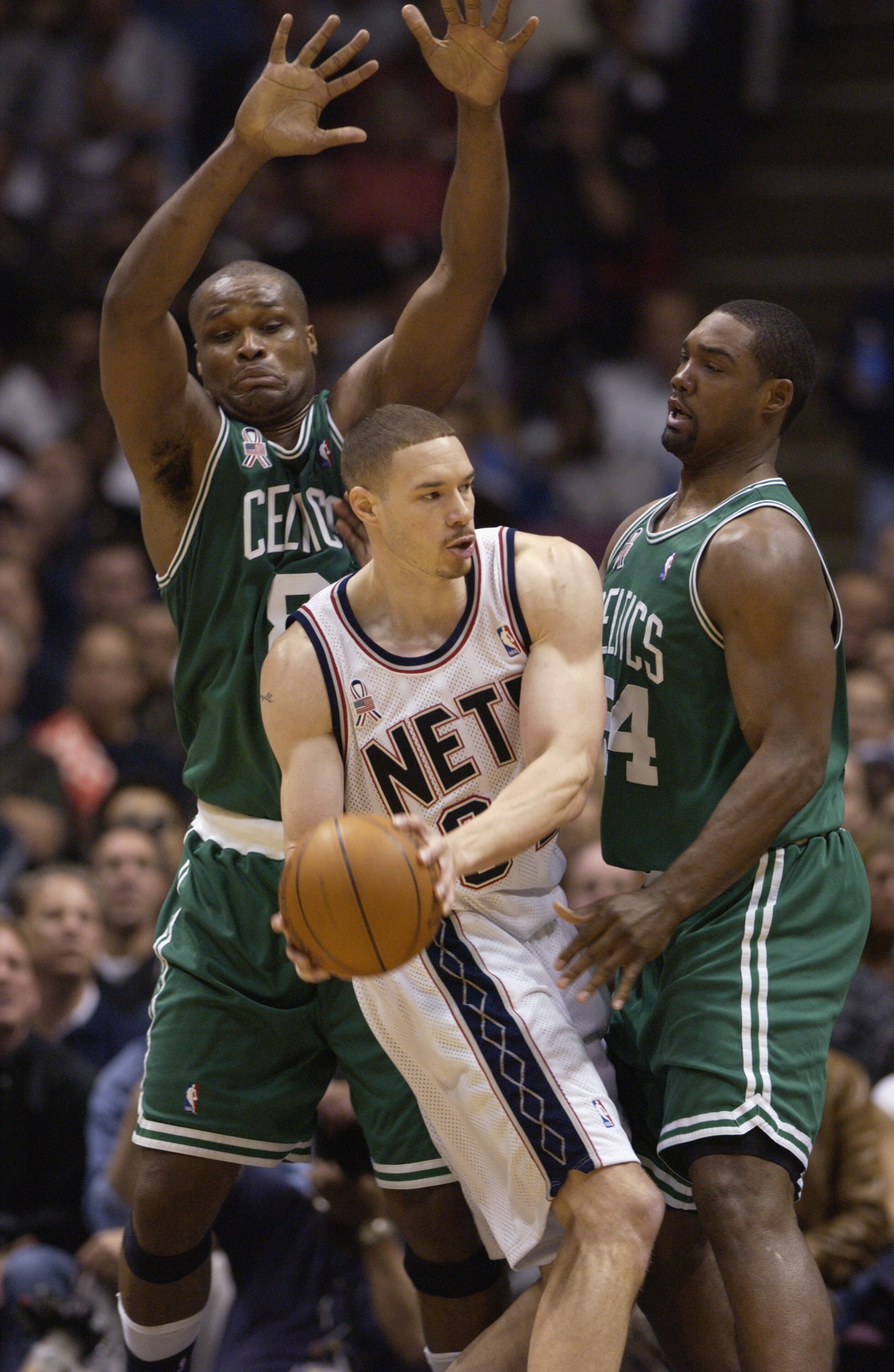EAST RUTHERFORD, NJ - MAY 21: Aaron Williams #34 of the New Jersey Nets looks to pass under pressure from Antoine Walker #8 and Rodney Rogers #54 of the Boston Celtics in Game two of the Eastern Conference Finals during the 2002 NBA Playoffs at Continenta